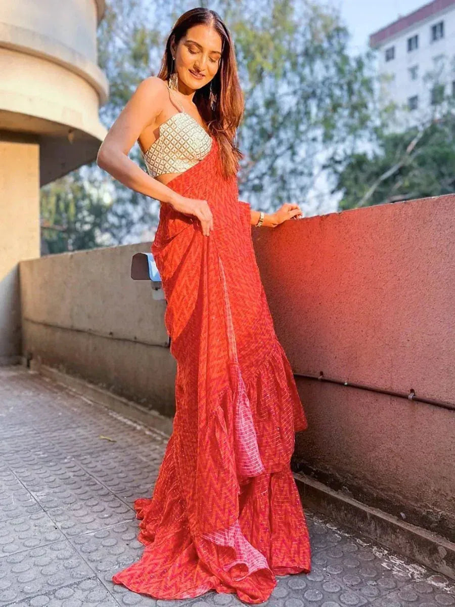 Woman in red printed saree with gold blouse, ethnic Indian wear for festive occasions