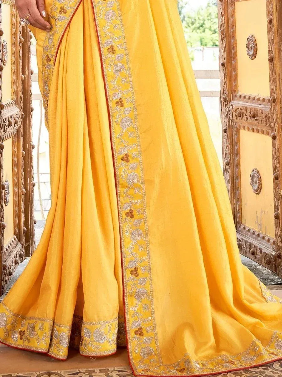 Yellow embroidered saree with floral border, perfect for Indian ethnic wear occasions