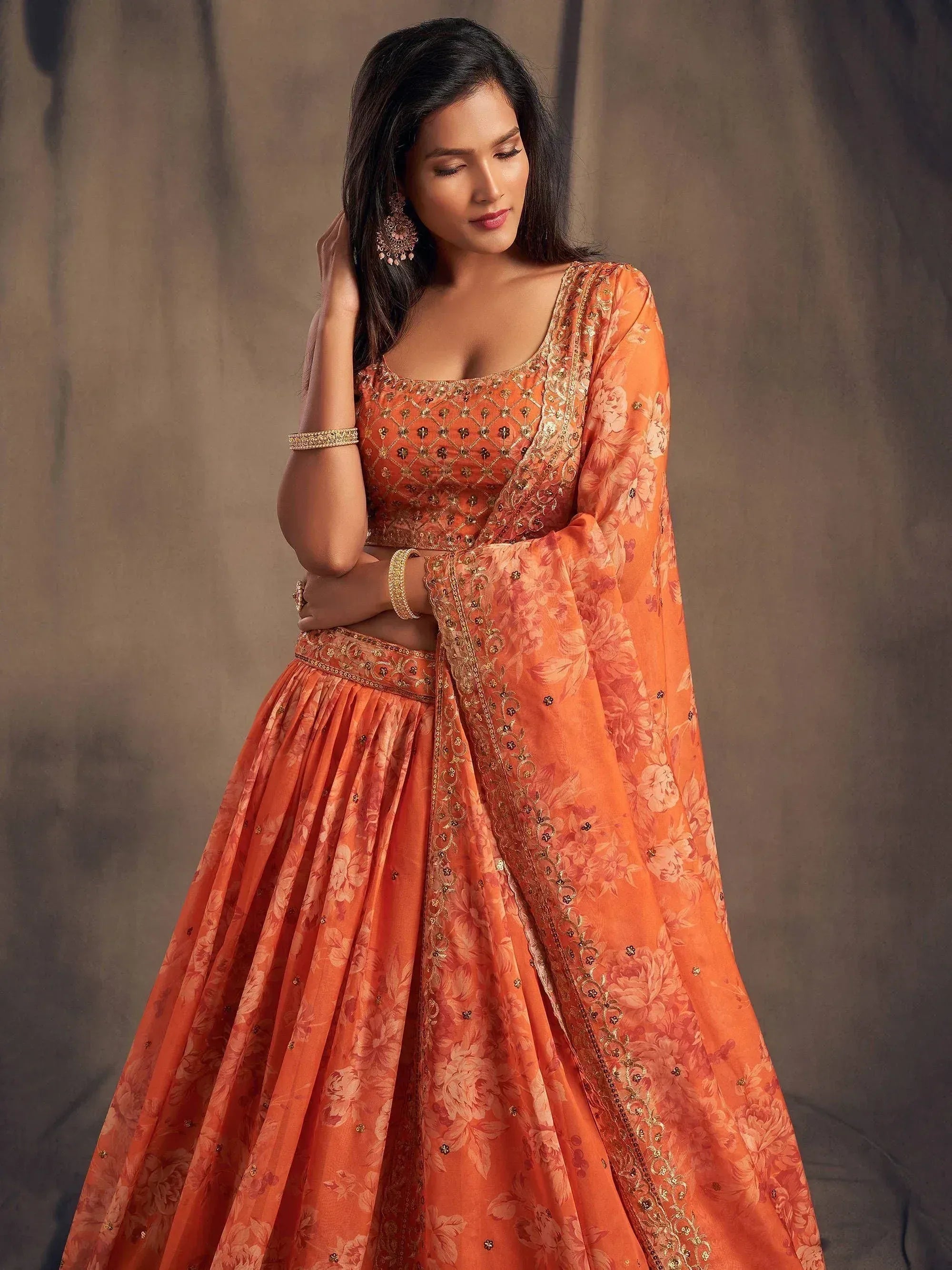 Orange floral lehenga choli with gold embroidery, perfect for Indian ethnic wear occasions
