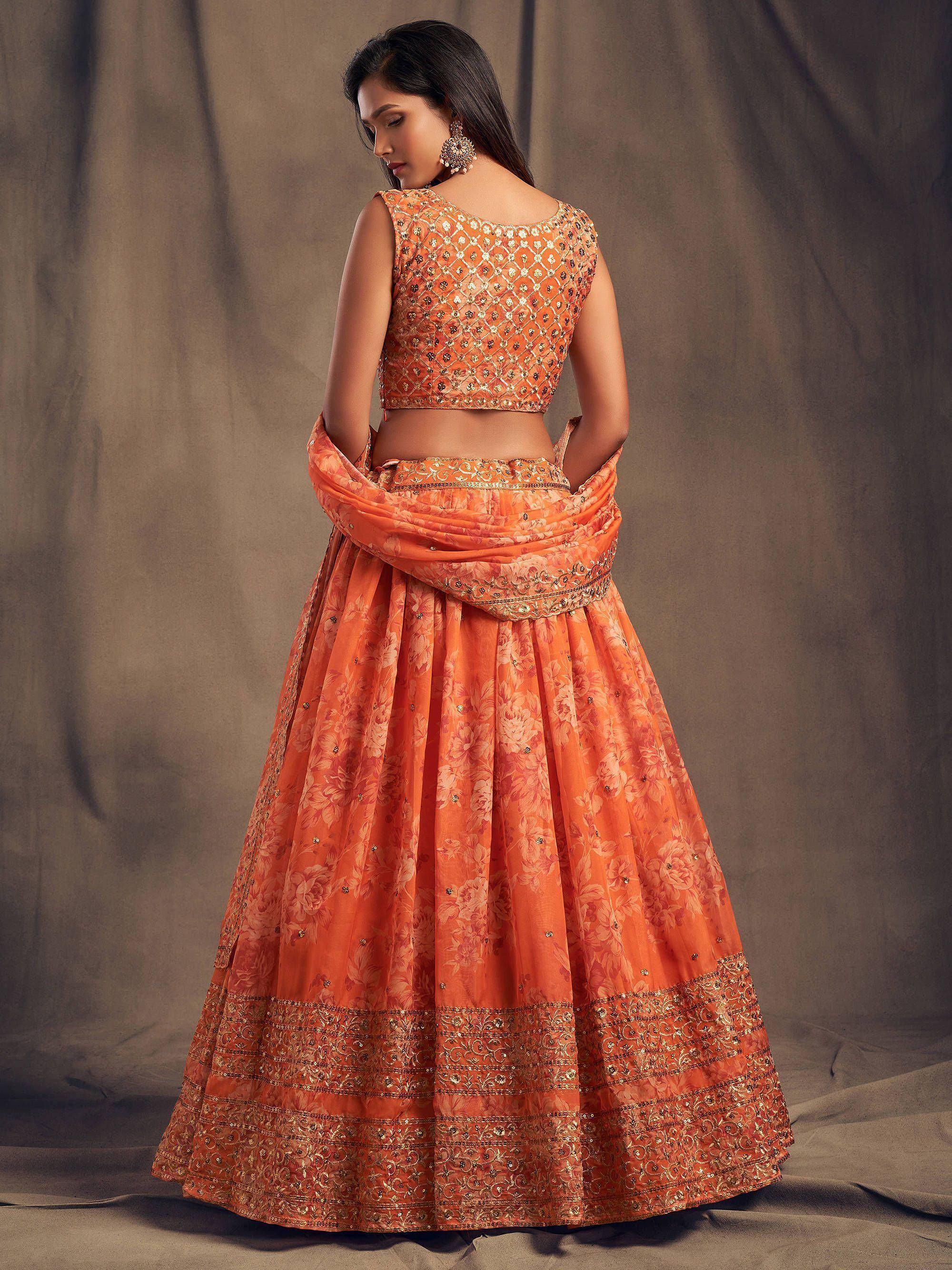 Orange floral lehenga choli with gold embroidery, perfect for Indian weddings and festive occasions