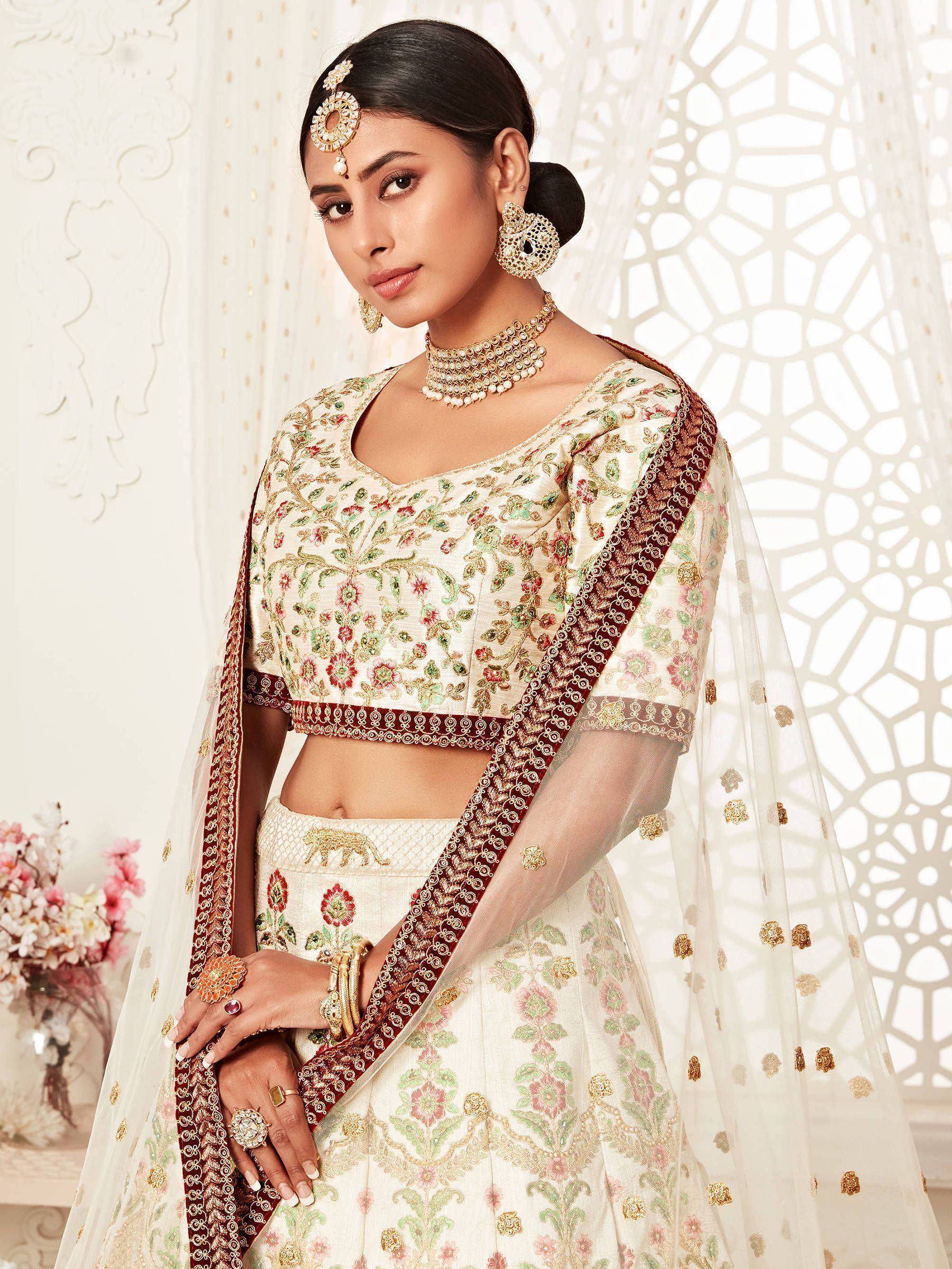Elegant ivory lehenga choli with floral embroidery, perfect for Indian weddings and festive occasions.