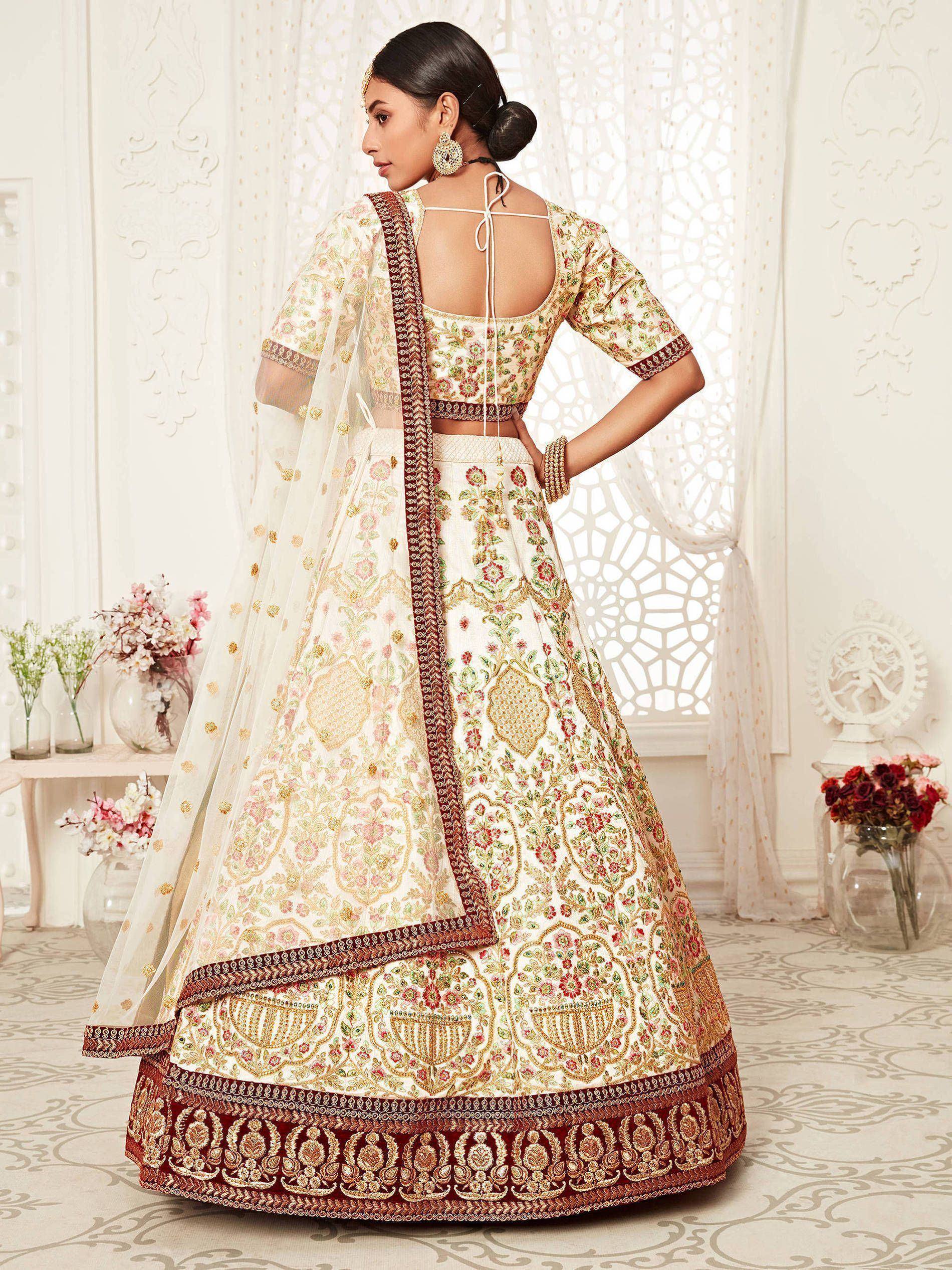 Elegant cream lehenga choli with floral embroidery, perfect for Indian weddings and festive occasions.