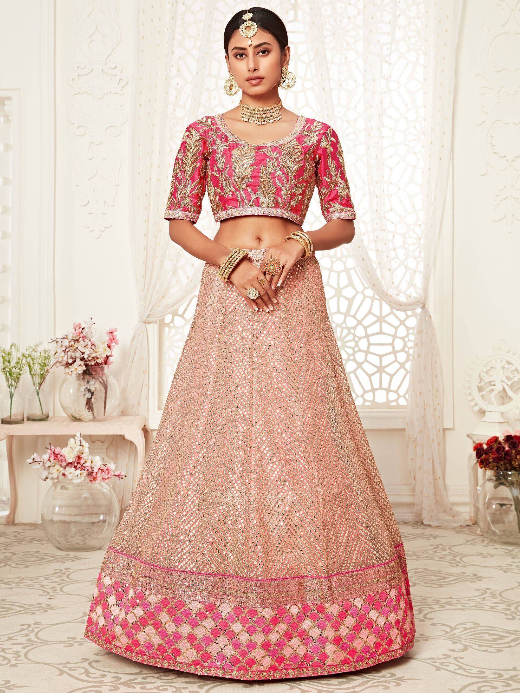 Pink and gold embroidered lehenga choli with mirror work, perfect for Indian weddings and festive occasions.