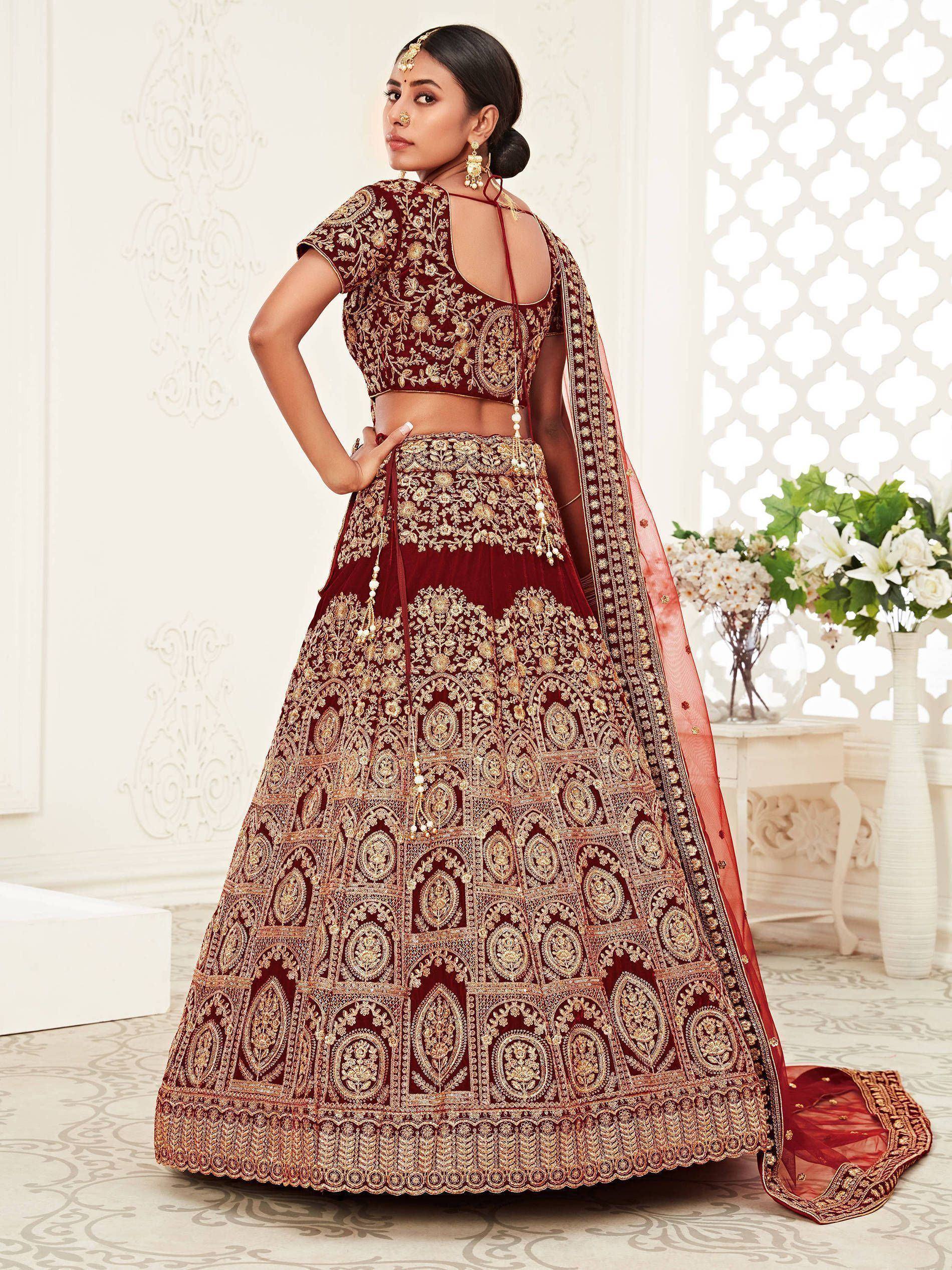 Maroon embroidered lehenga choli with gold detailing, perfect for Indian weddings and festive occasions.