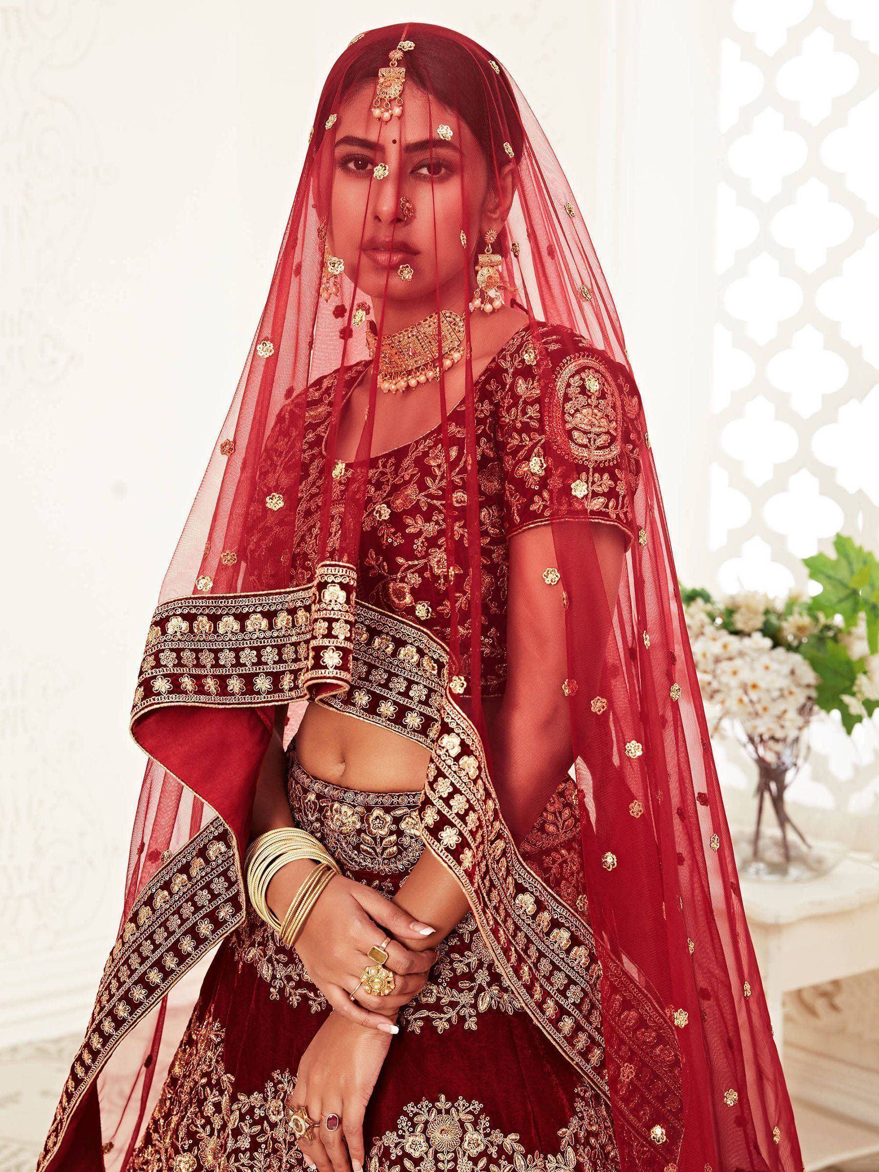 Red embroidered lehenga choli with gold detailing and matching dupatta, traditional Indian bridal wear