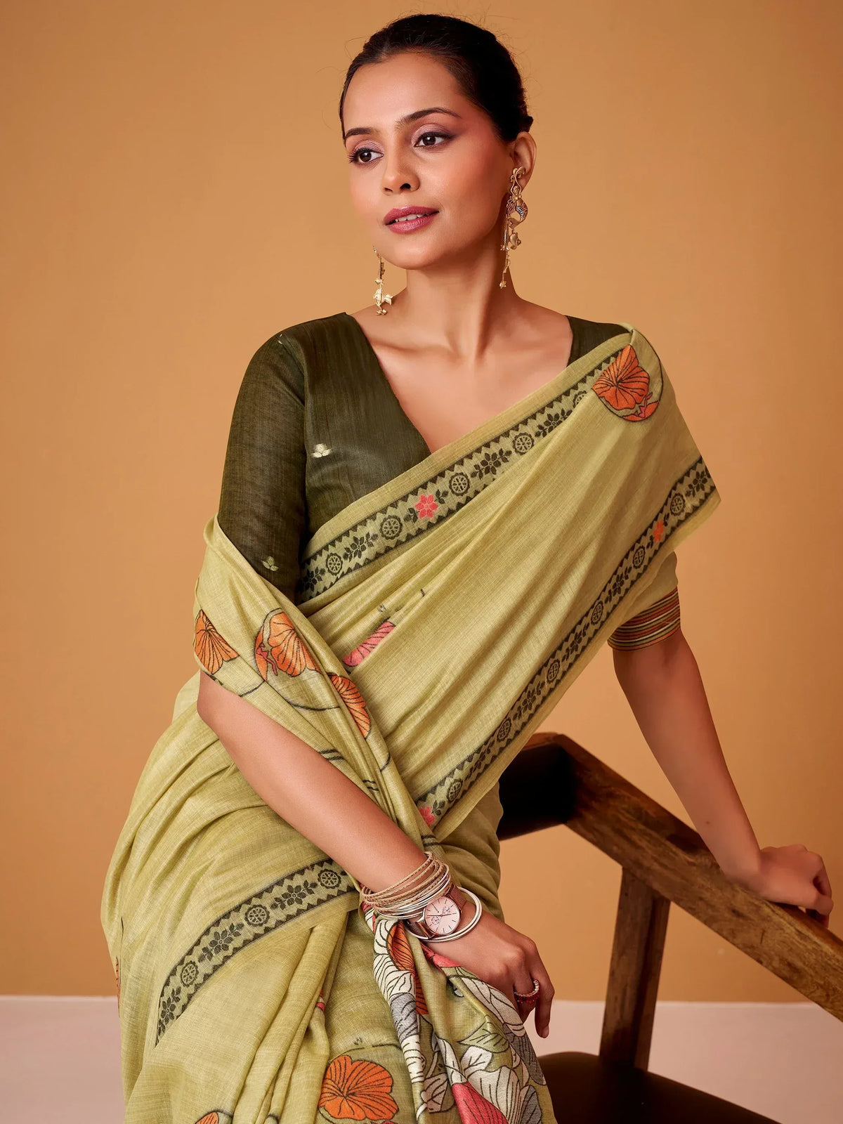 Olive green saree with floral print and border, paired with matching blouse, perfect for ethnic occasions.