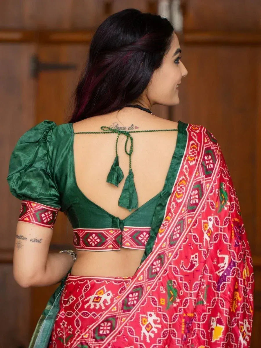 Woman in red printed saree with green puff sleeve blouse, back view, ethnic wear