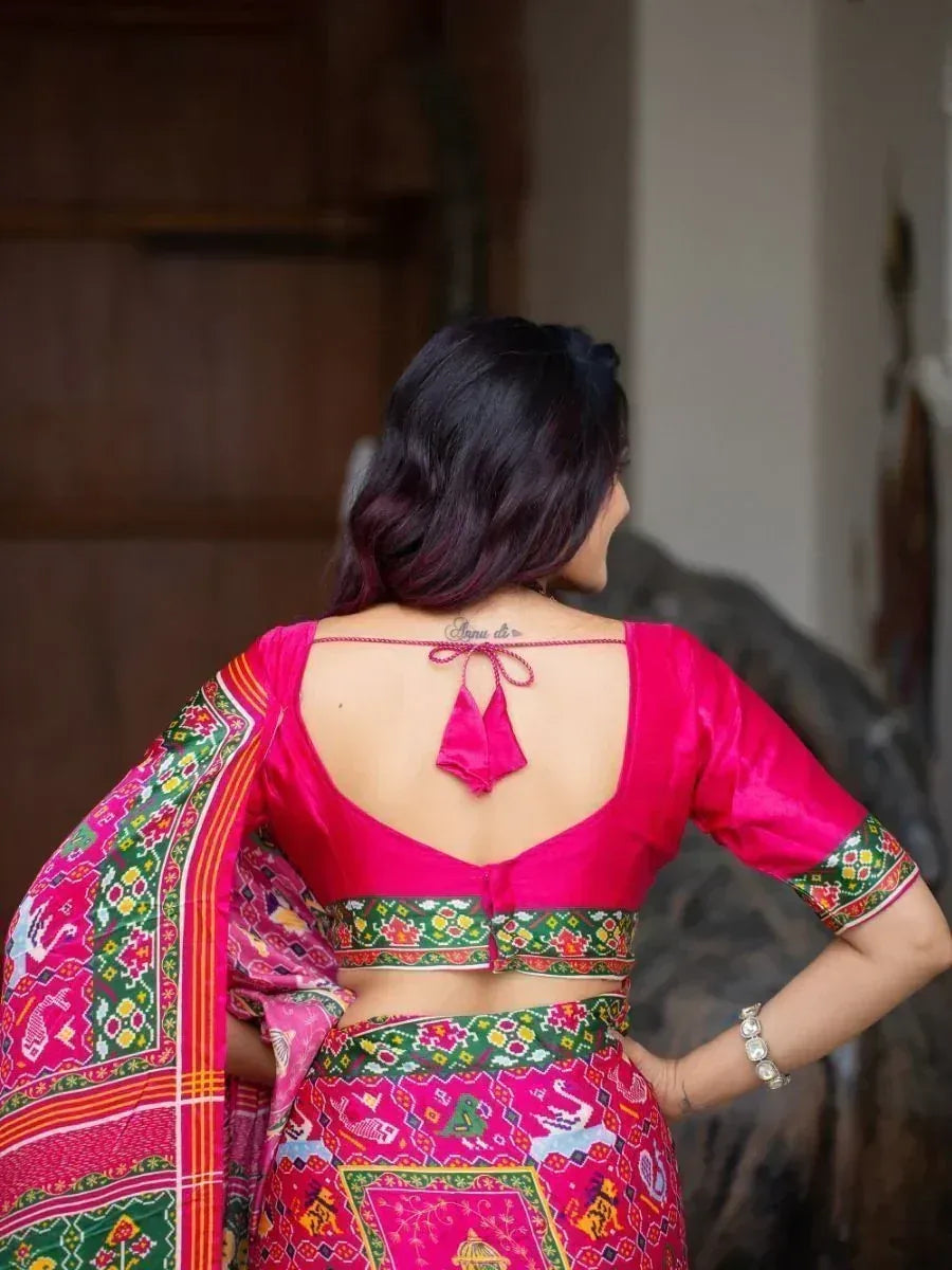 Pink backless blouse with tie detail, paired with colorful printed saree, ethnic Indian wear