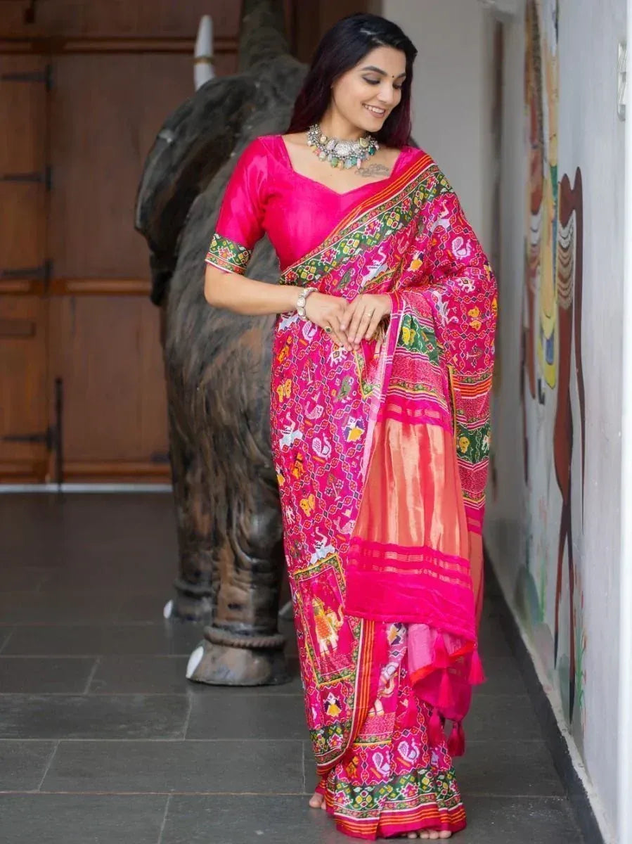 Vibrant pink ethnic saree with colorful embroidery, paired with matching blouse, perfect for Indian festive occasions.