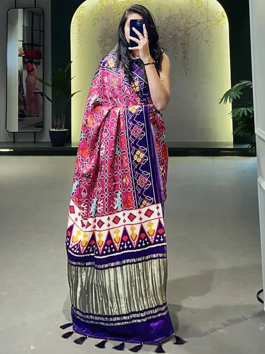 Vibrant pink and purple ethnic saree with intricate geometric patterns and tassel hem, perfect for festive occasions.