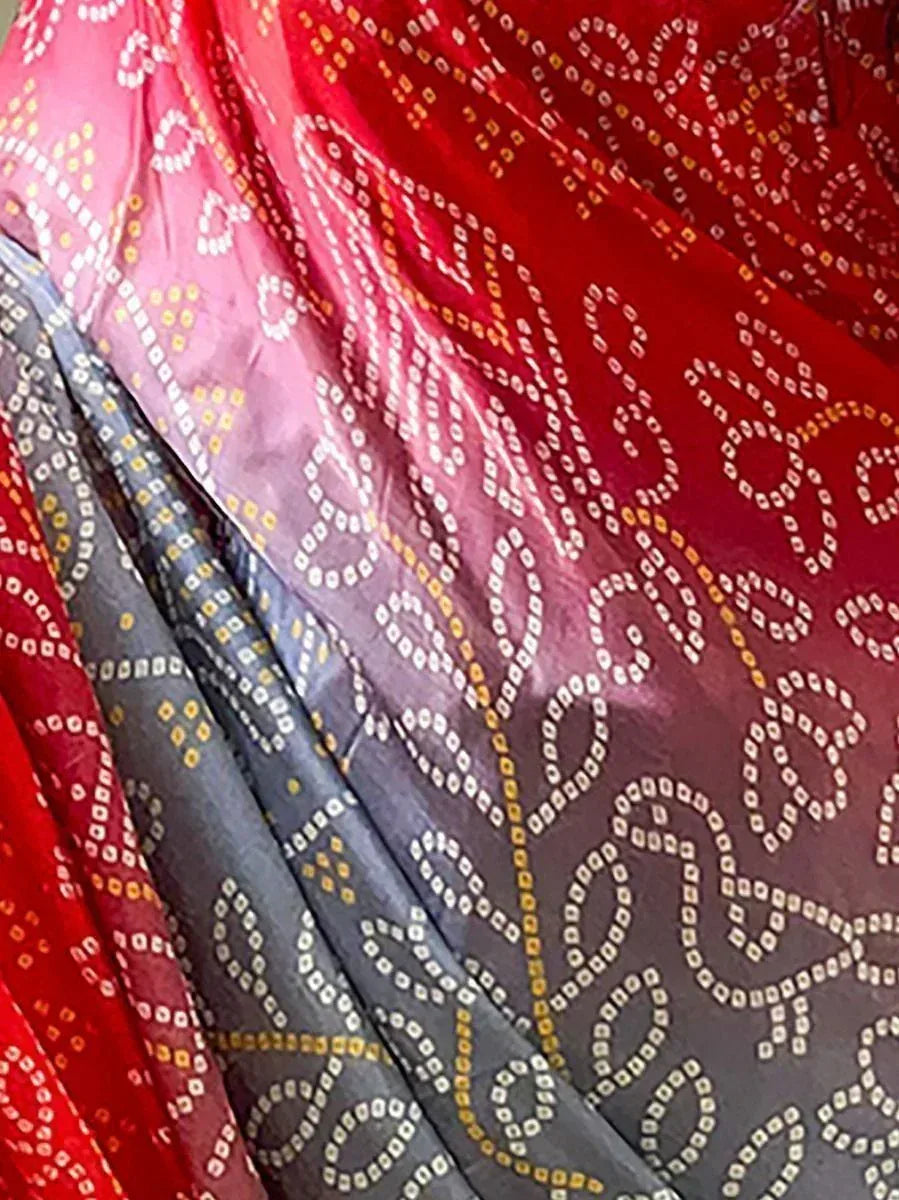 Red and gray ethnic saree with intricate white and yellow dot patterns, perfect for traditional Indian wear.