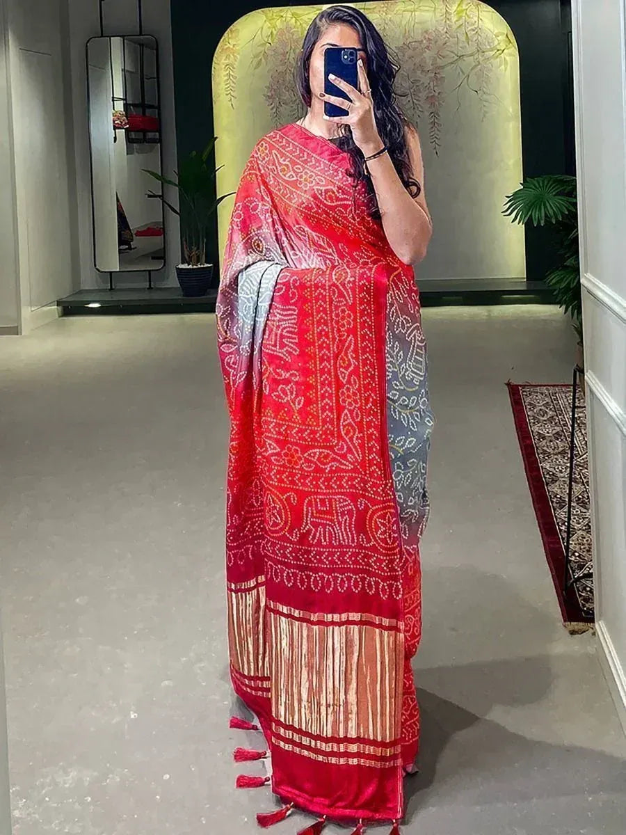 Red and gray printed saree with elephant motifs and tassels, styled for ethnic wear