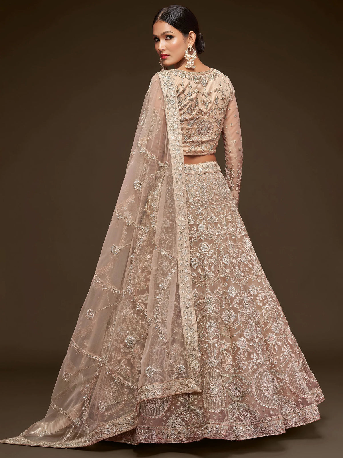 Ravishing Beige Embroidered Soft Net Ceremony Wear Lehenga Choli