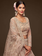 Ravishing Beige Embroidered Soft Net Ceremony Wear Lehenga Choli
