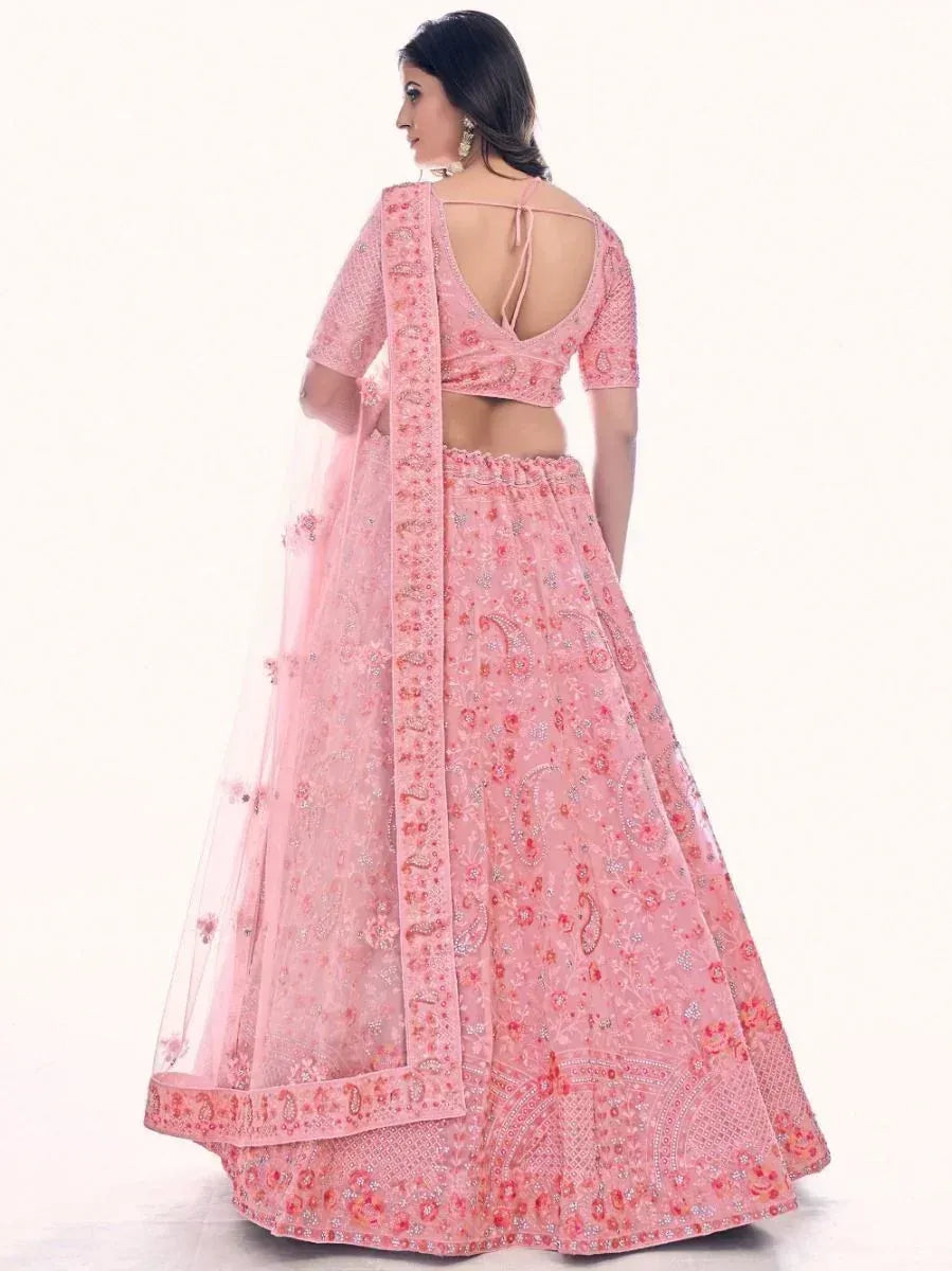 Pink embroidered lehenga choli with backless blouse and floral dupatta, perfect for Indian weddings and parties