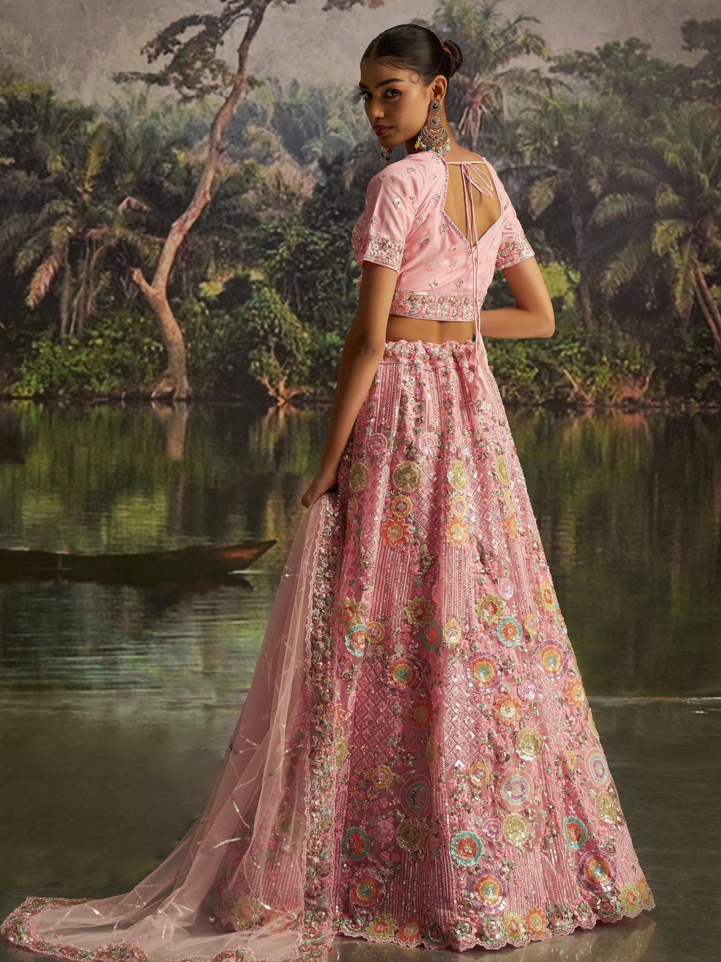 Pink embroidered lehenga choli with floral motifs, perfect for Indian ethnic wear and festive occasions.