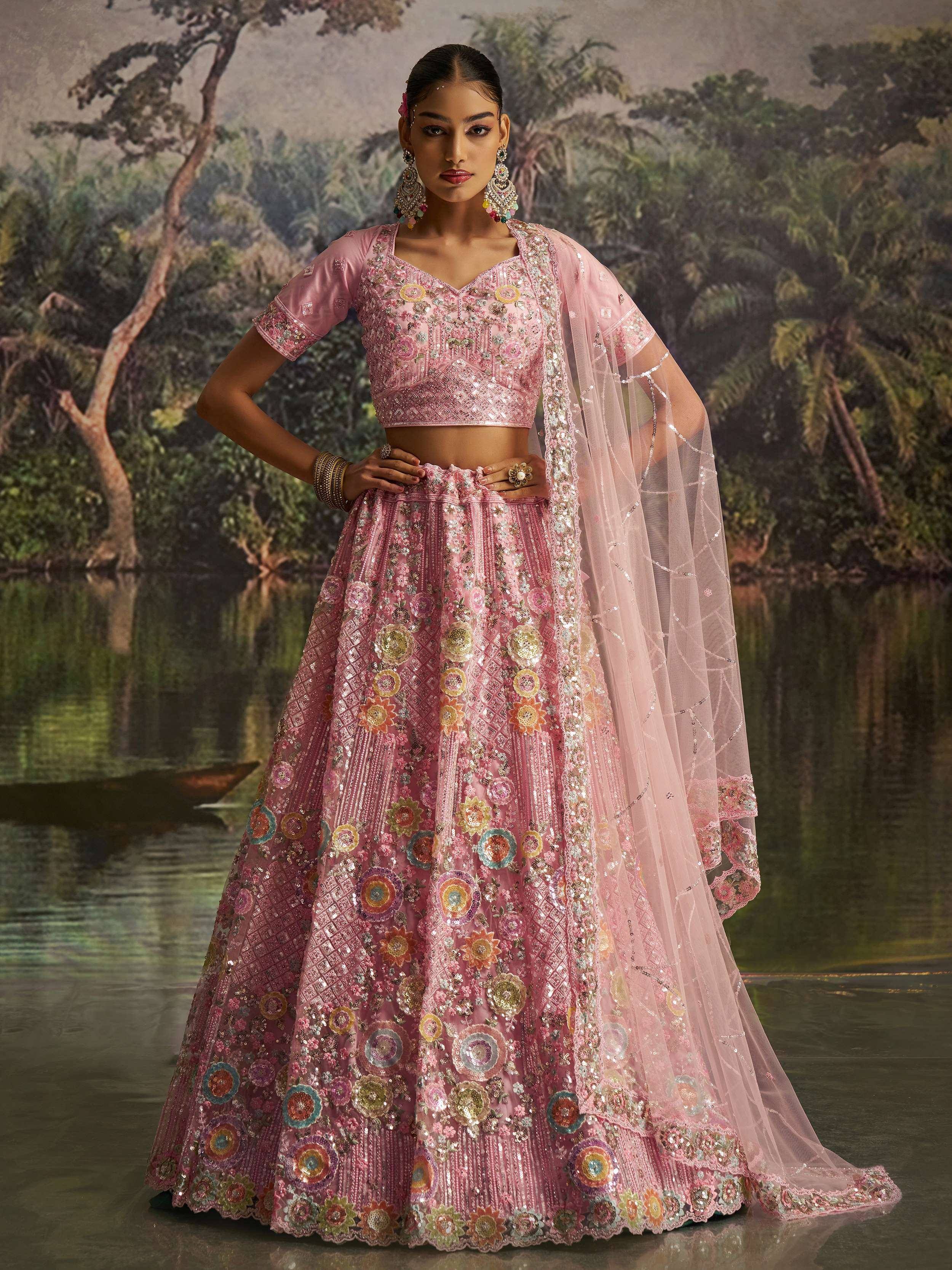 Pink embroidered lehenga choli with floral motifs and sheer dupatta, perfect for Indian ethnic wear events.