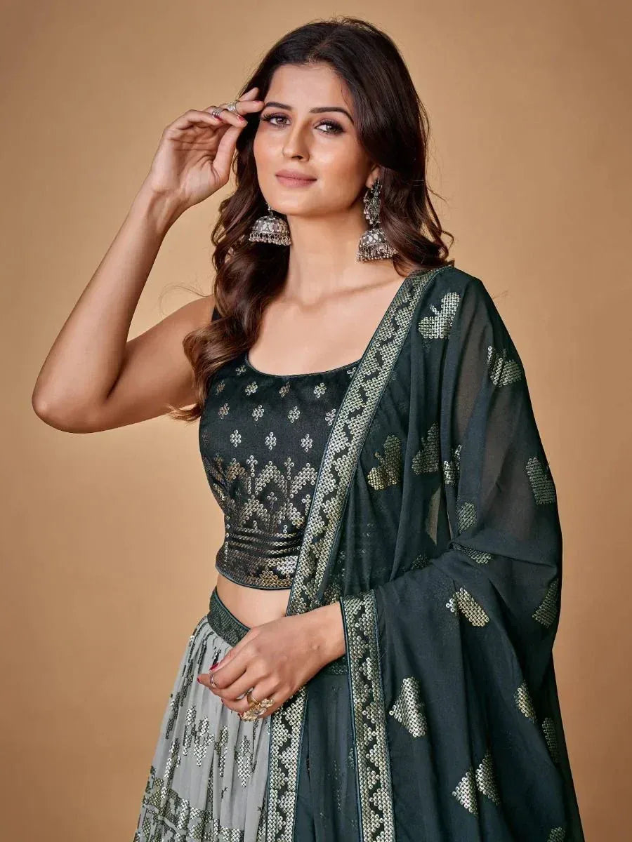 Elegant dark green sequin lehenga choli with matching dupatta, perfect for Indian ethnic occasions.