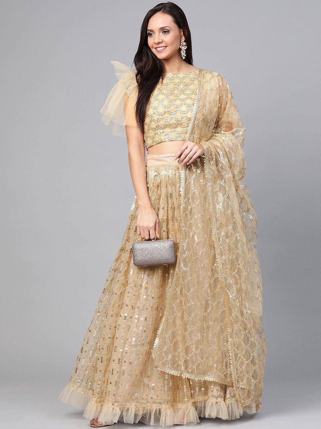 Gold sequin lehenga choli with sheer dupatta, perfect for Indian weddings and festive occasions