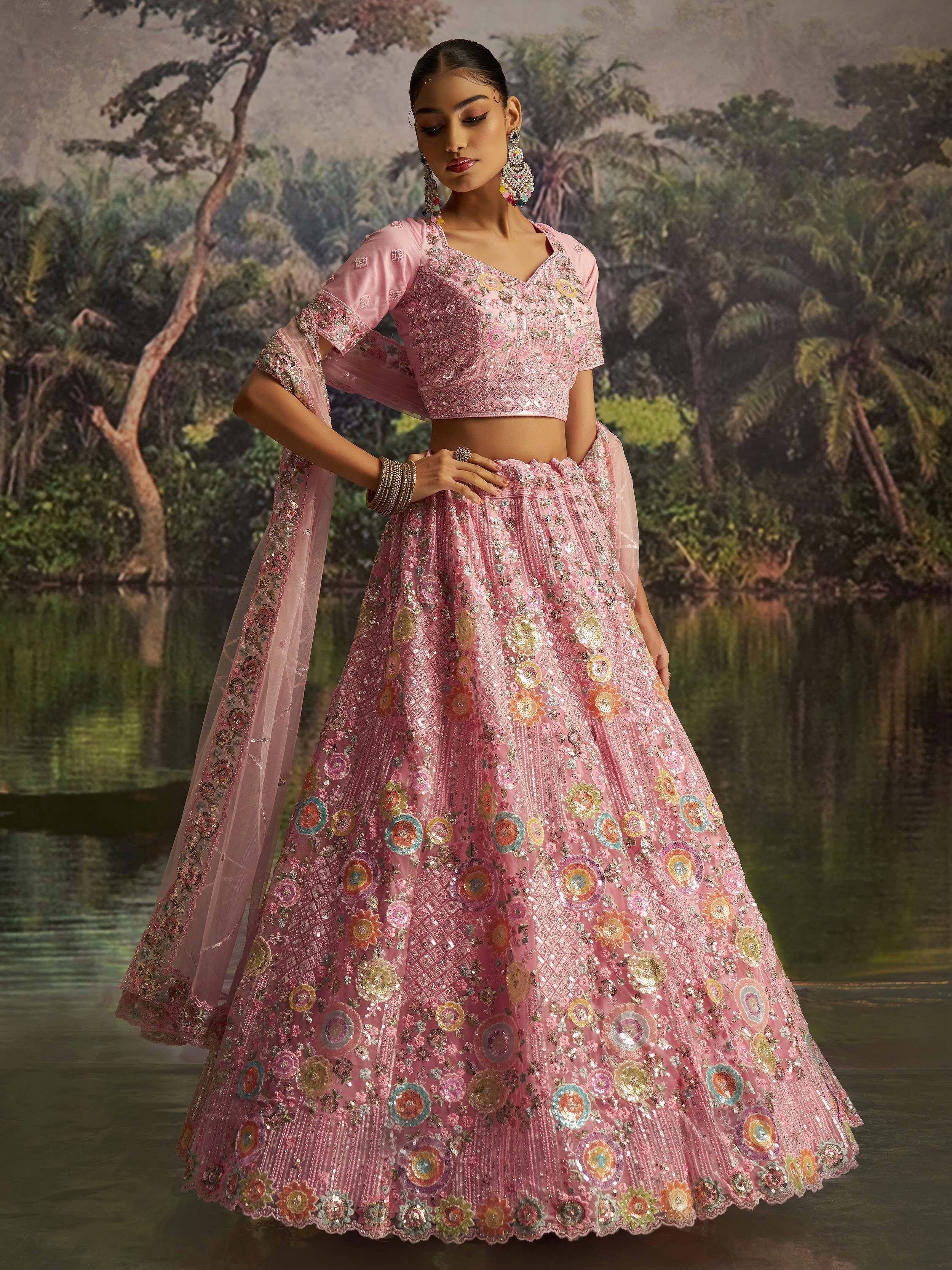 Pink embroidered lehenga choli with floral motifs, perfect for Indian ethnic wear and festive occasions.