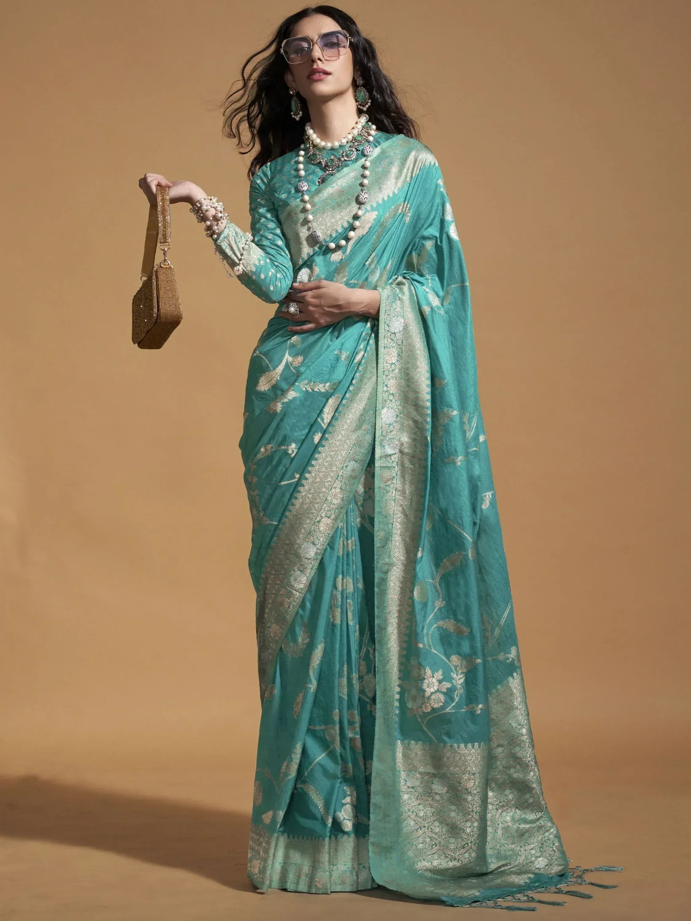 Teal designer saree with gold floral embroidery, perfect for Indian ethnic wear occasions.