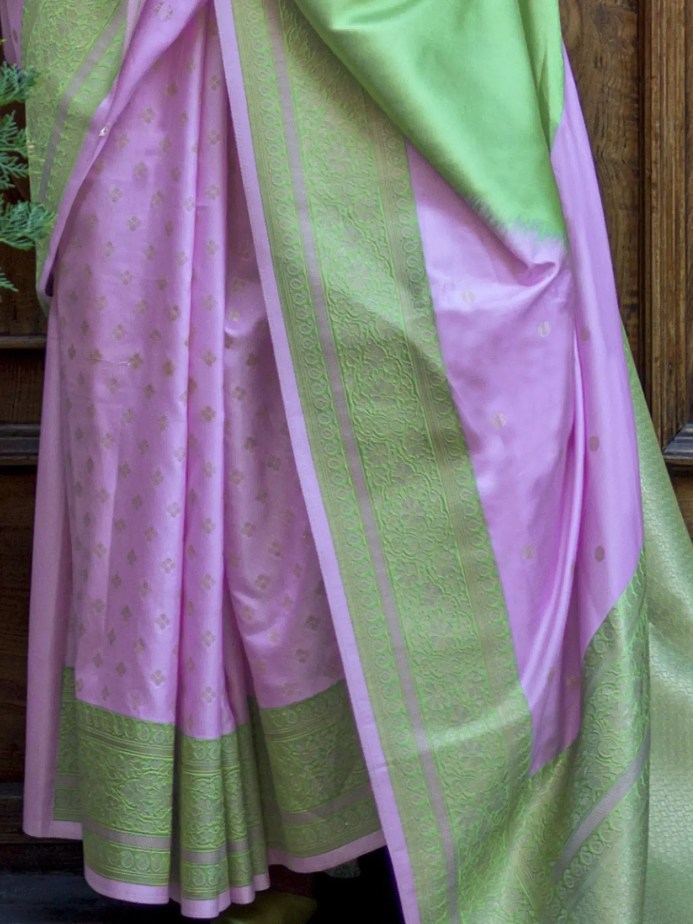 Pink and green designer saree with intricate border and floral motifs, perfect for ethnic occasions