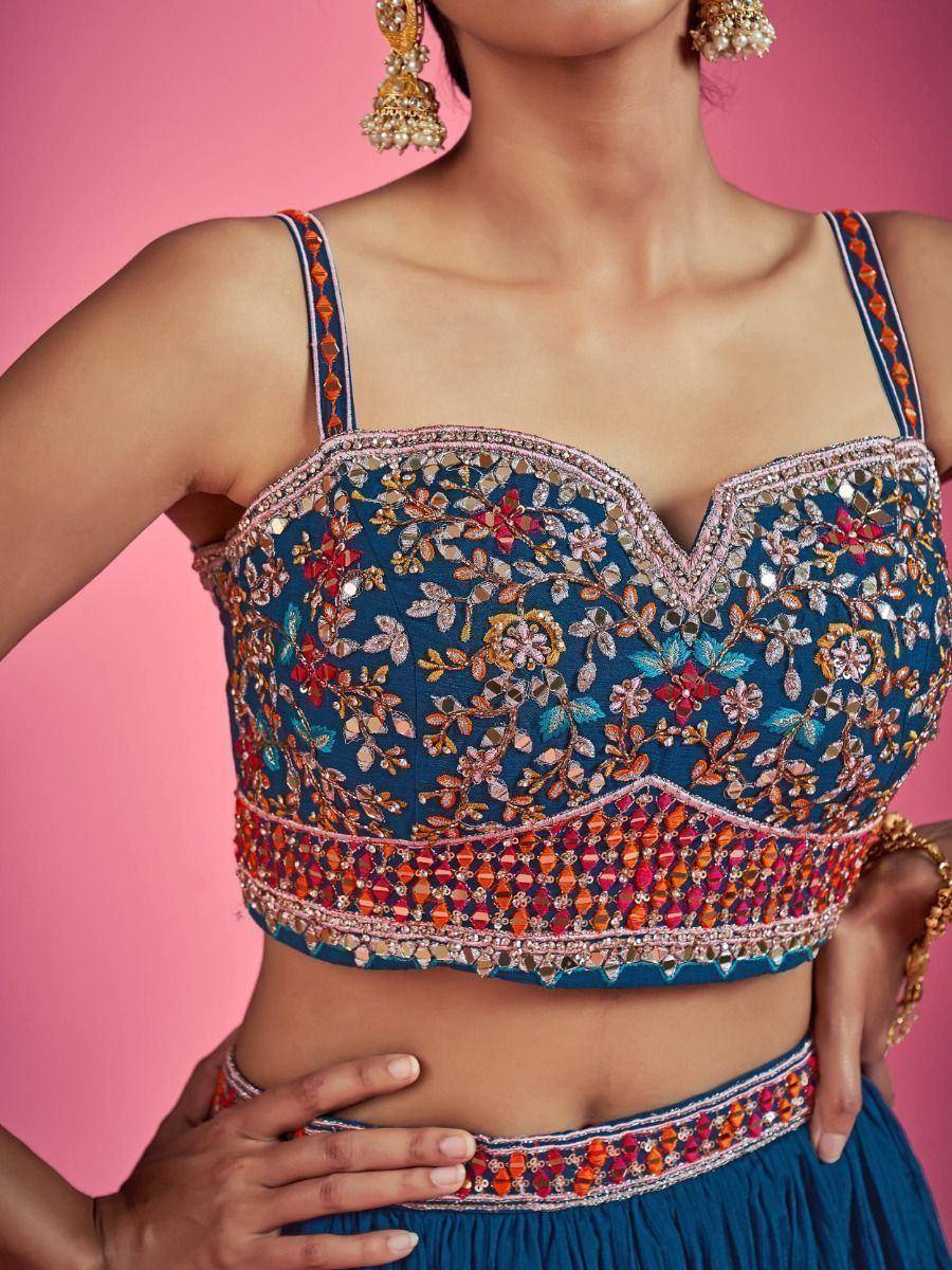 Blue embroidered lehenga choli top with floral mirror work and colorful detailing, paired with matching skirt.
