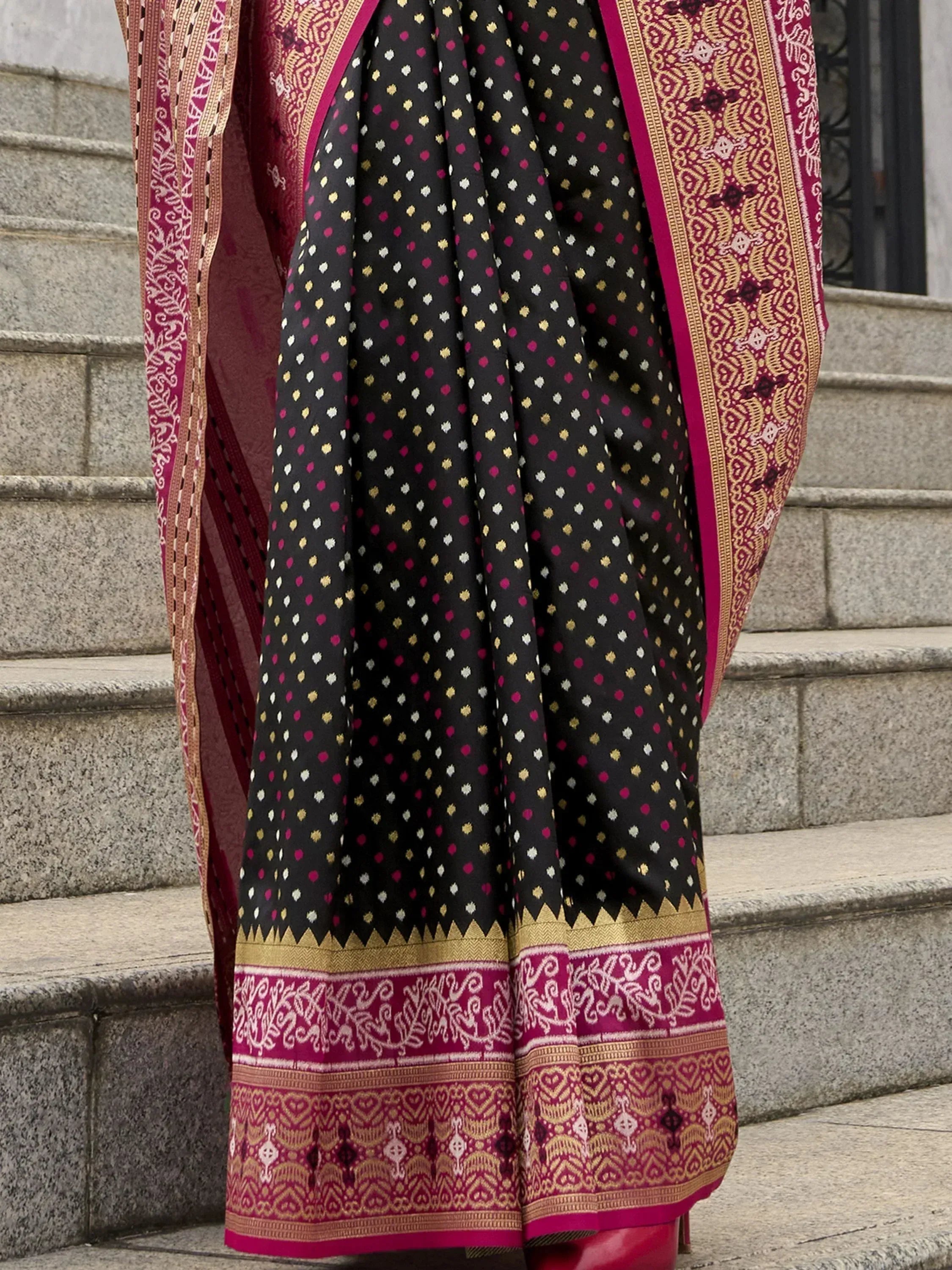 Black and magenta ethnic saree with gold polka dots and intricate border, perfect for Indian occasions
