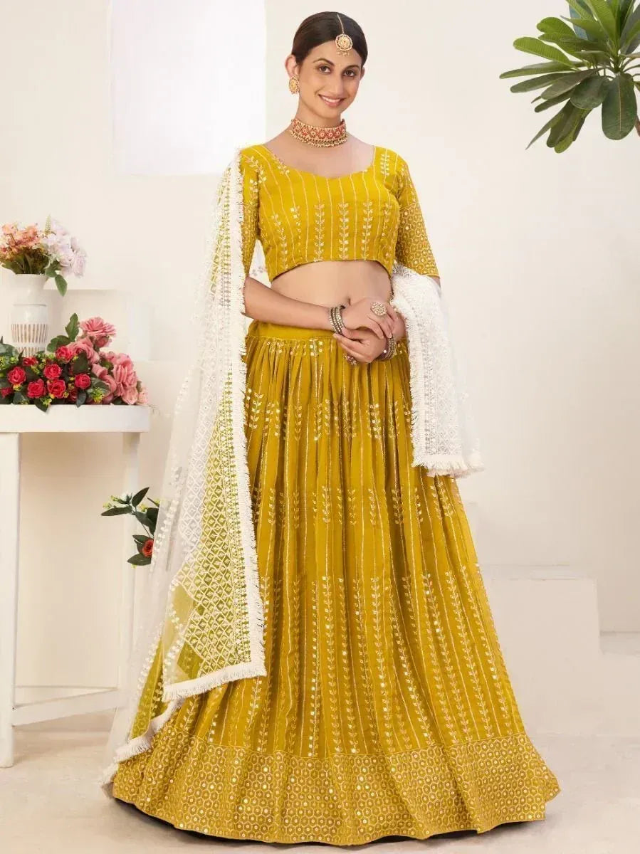 Yellow embroidered lehenga choli with white dupatta, perfect for Indian ethnic occasions and weddings