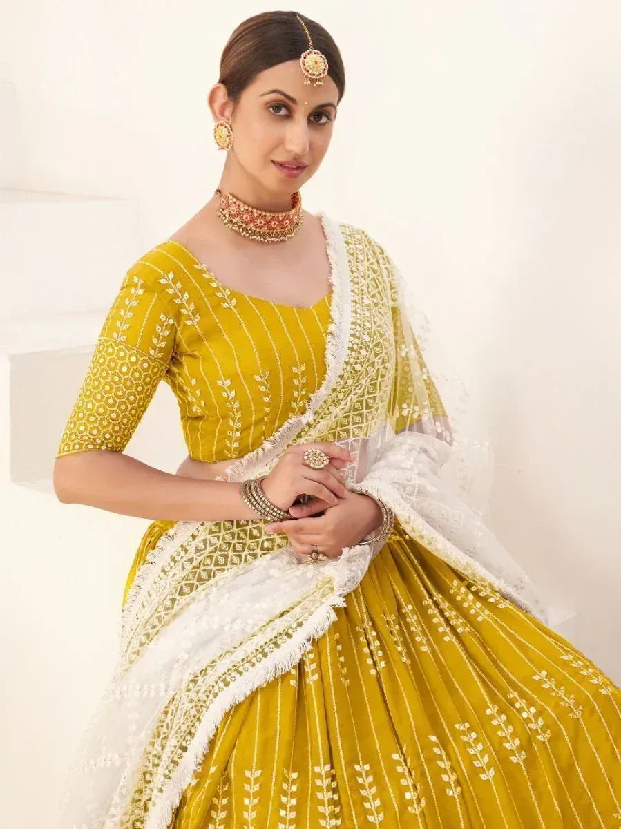 Yellow embroidered lehenga choli with white dupatta, perfect for Indian ethnic wear occasions