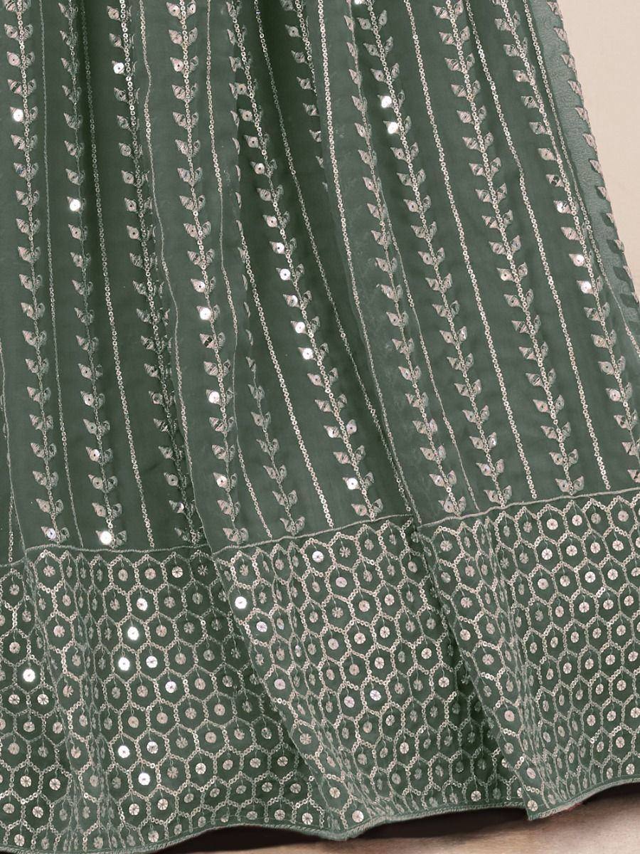 Green ethnic lehenga with silver leaf and sequin embroidery, perfect for Indian weddings and festivals.