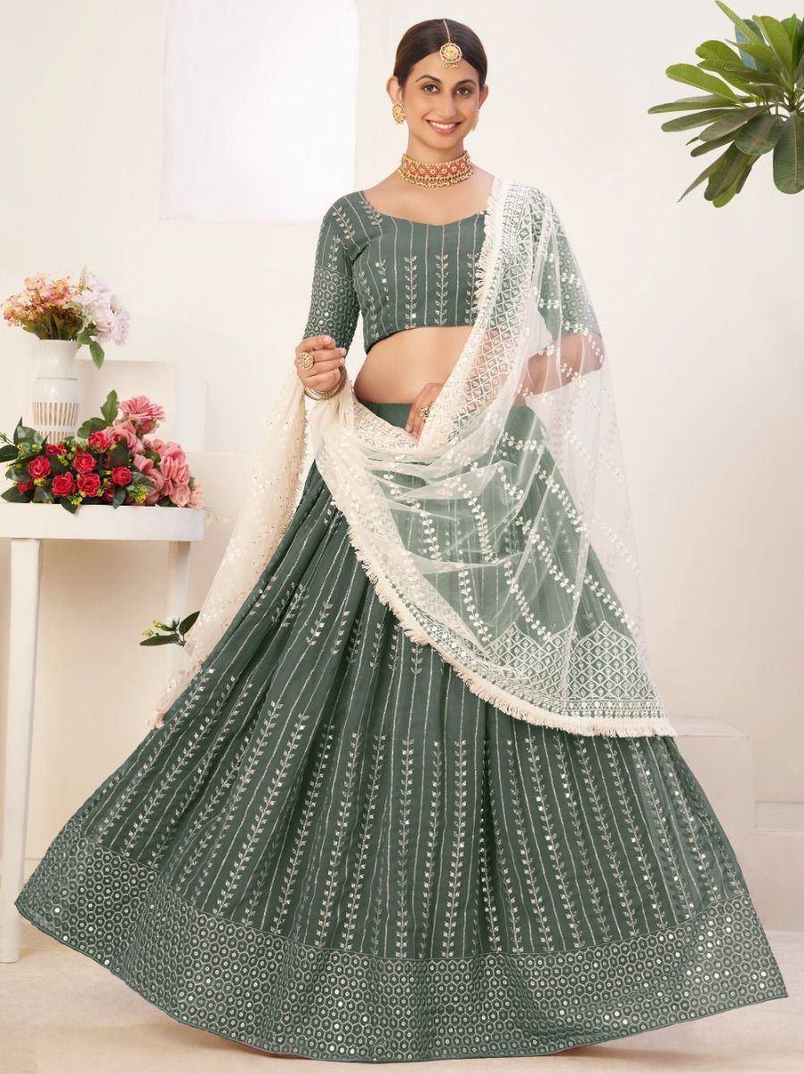 Green embroidered lehenga choli with white dupatta, perfect for Indian weddings and festive occasions.