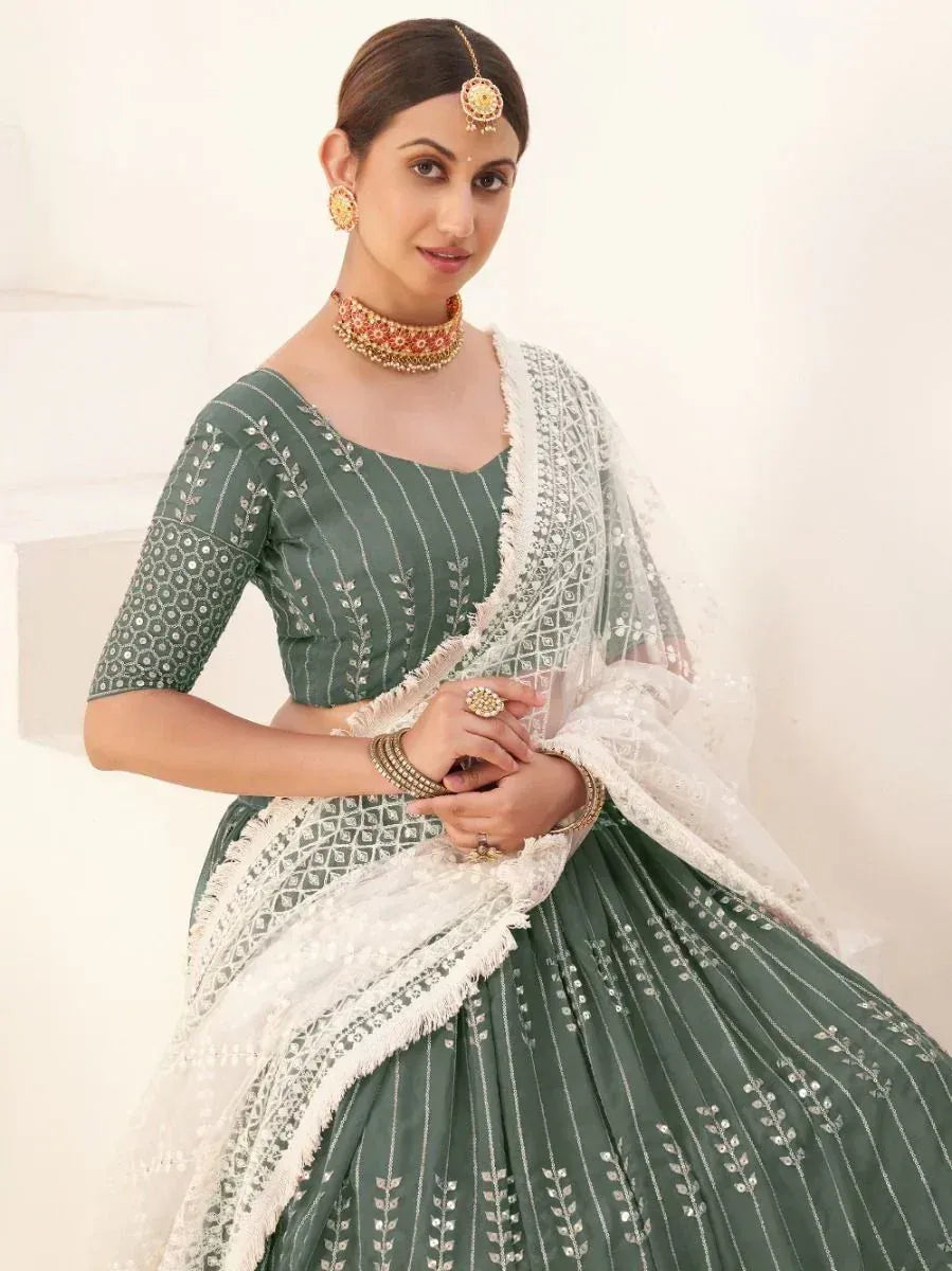 Elegant green lehenga choli with white dupatta, perfect for Indian ethnic wear and festive occasions.