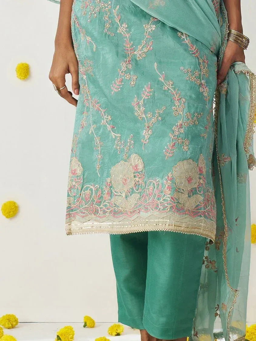 Teal embroidered salwar kameez with floral zari work, perfect for ethnic occasions