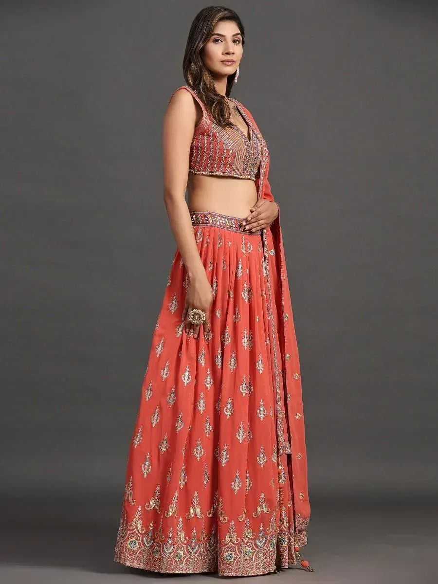 Coral designer lehenga choli with intricate gold embroidery and matching dupatta for Indian ethnic wear
