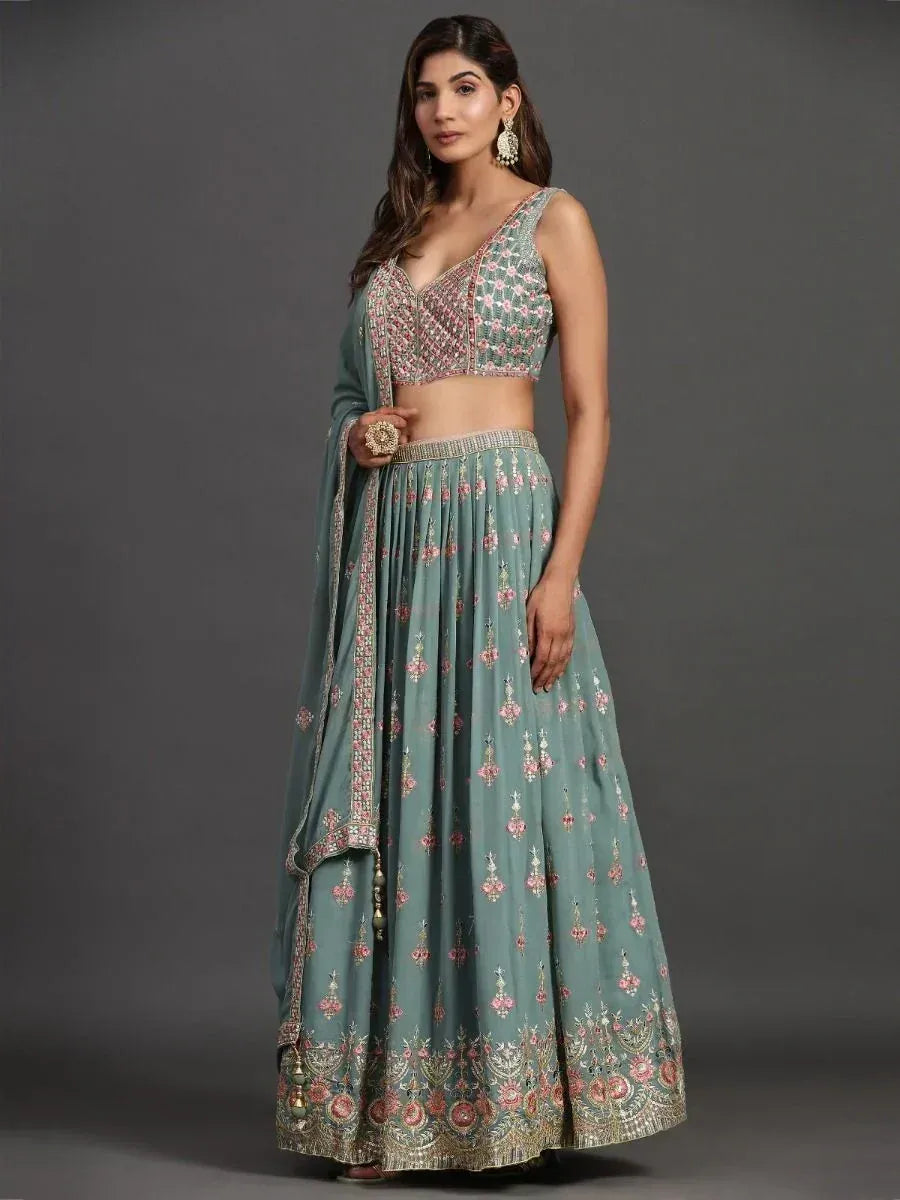 Teal embroidered lehenga choli with floral motifs and matching dupatta, ideal for Indian ethnic occasions.