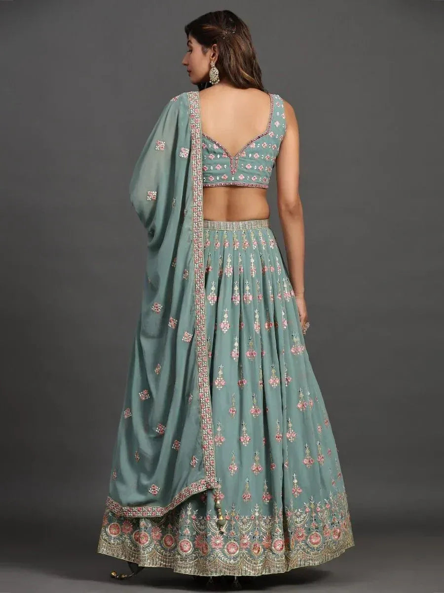 Mint green embroidered lehenga choli with floral motifs and backless blouse, perfect for Indian ethnic wear occasions