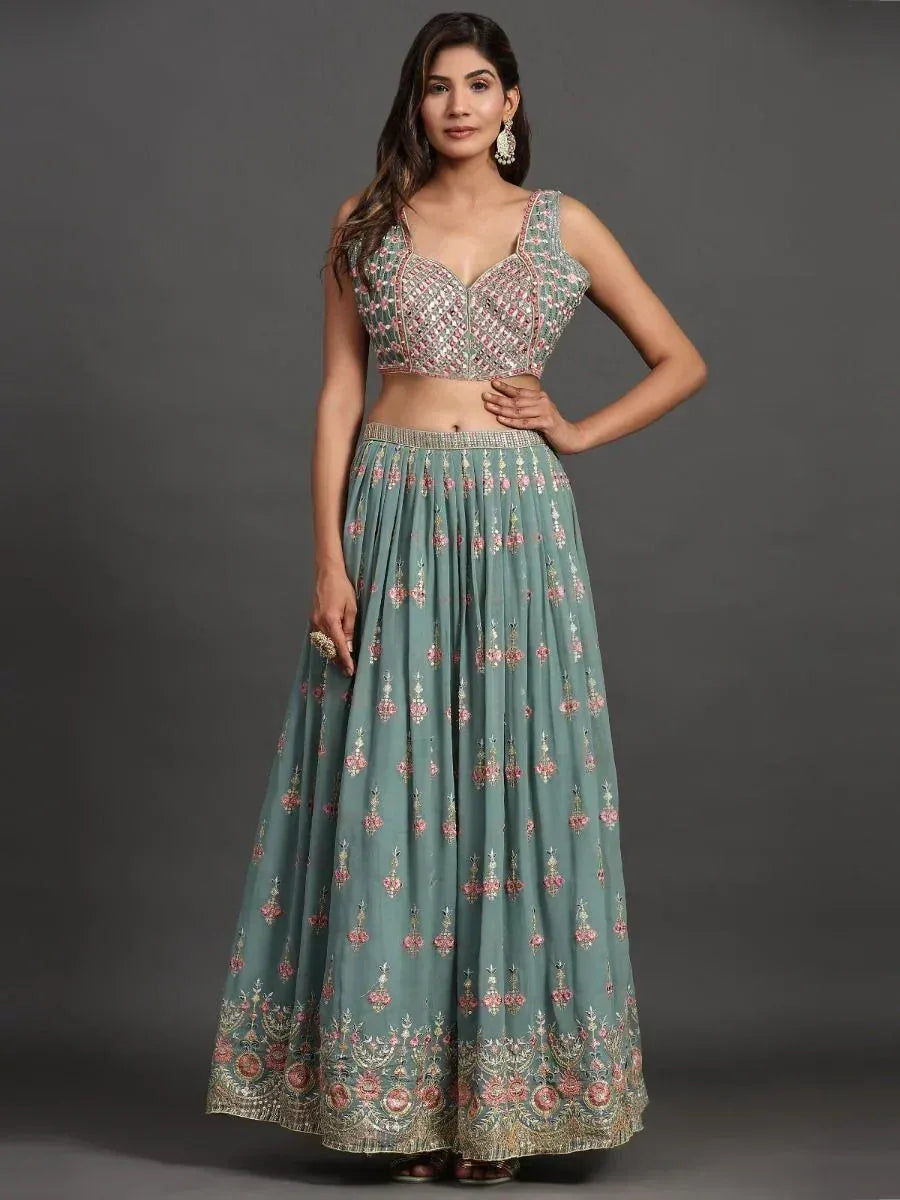 Green floral embroidered lehenga choli with embellished crop top and flared skirt, perfect for Indian ethnic occasions.