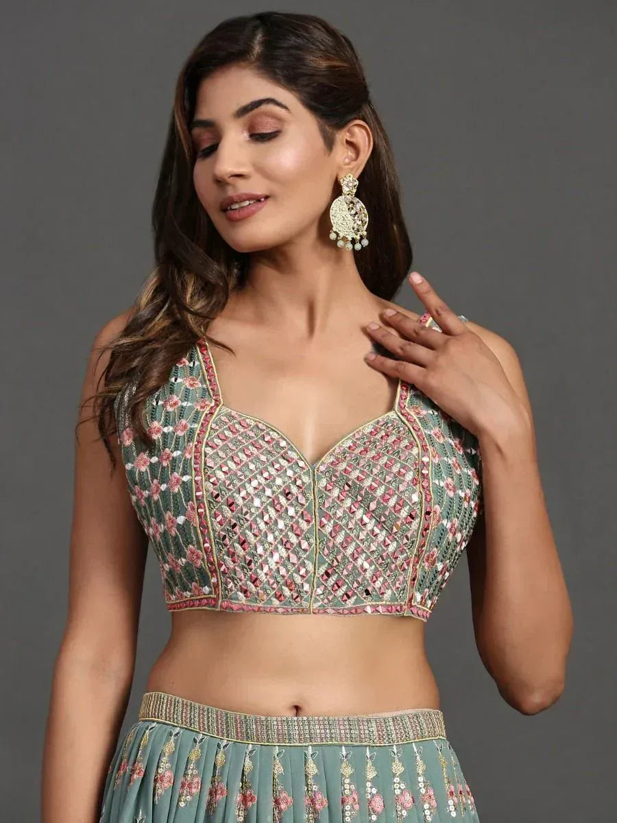 Designer lehenga choli with floral embroidery and mirror work, perfect for Indian ethnic wear occasions.
