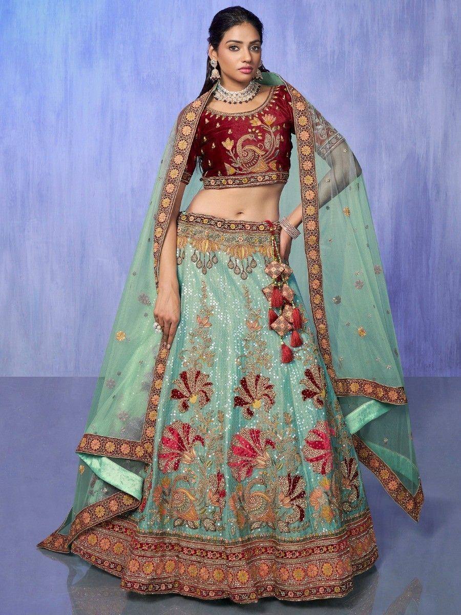 Designer lehenga choli with peacock embroidery, mint green skirt, maroon blouse, and sheer dupatta for Indian ethnic wear