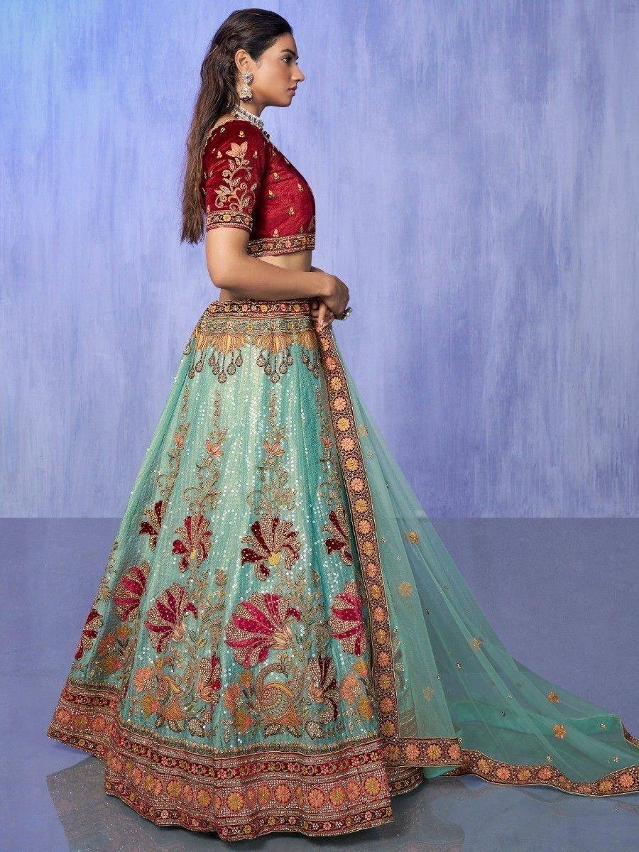 Elegant teal and red embroidered lehenga choli with floral motifs, perfect for Indian weddings and festive occasions.