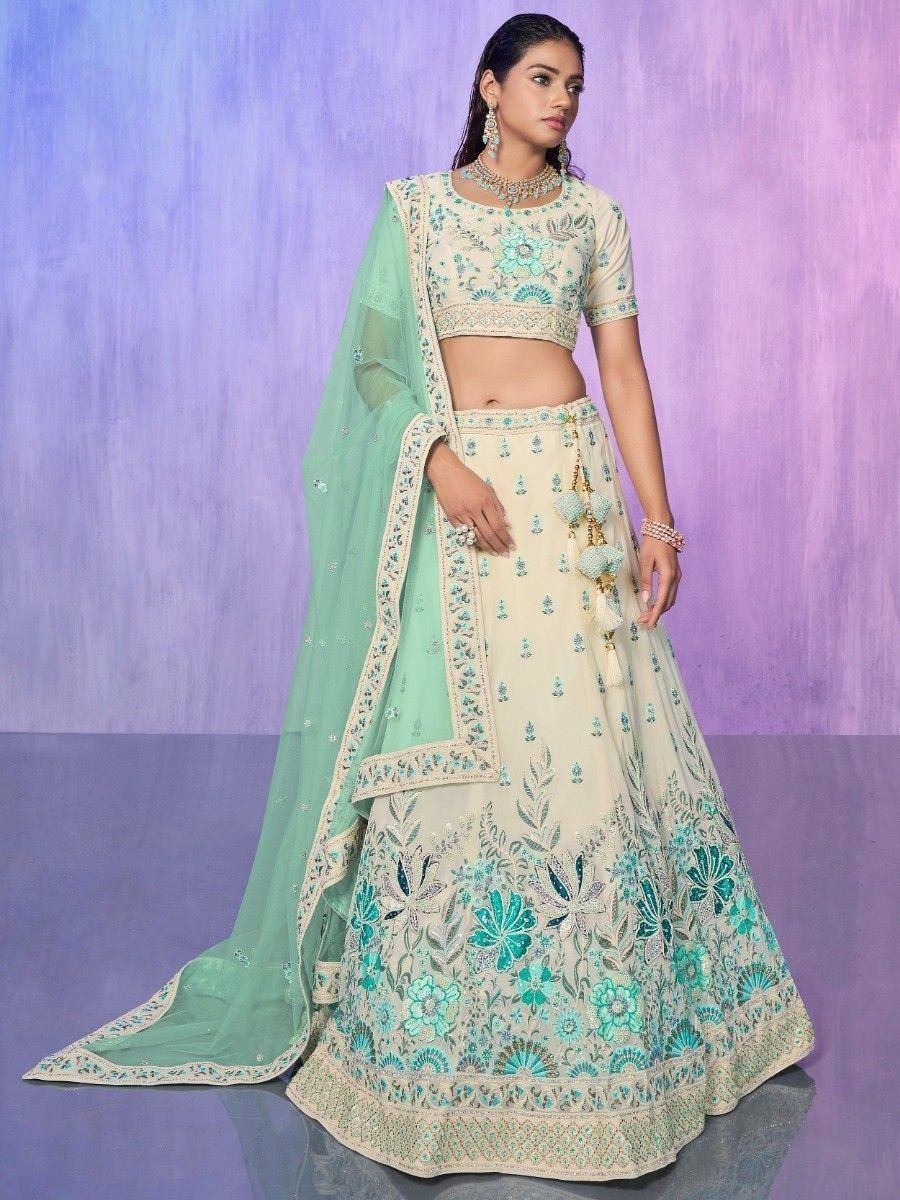 Cream and mint green embroidered lehenga choli with floral motifs and matching dupatta, perfect for Indian ethnic occasions.