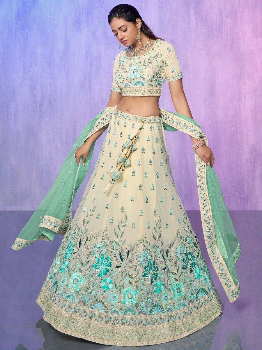 Cream and mint green embroidered lehenga choli with floral motifs and dupatta, perfect for Indian ethnic occasions