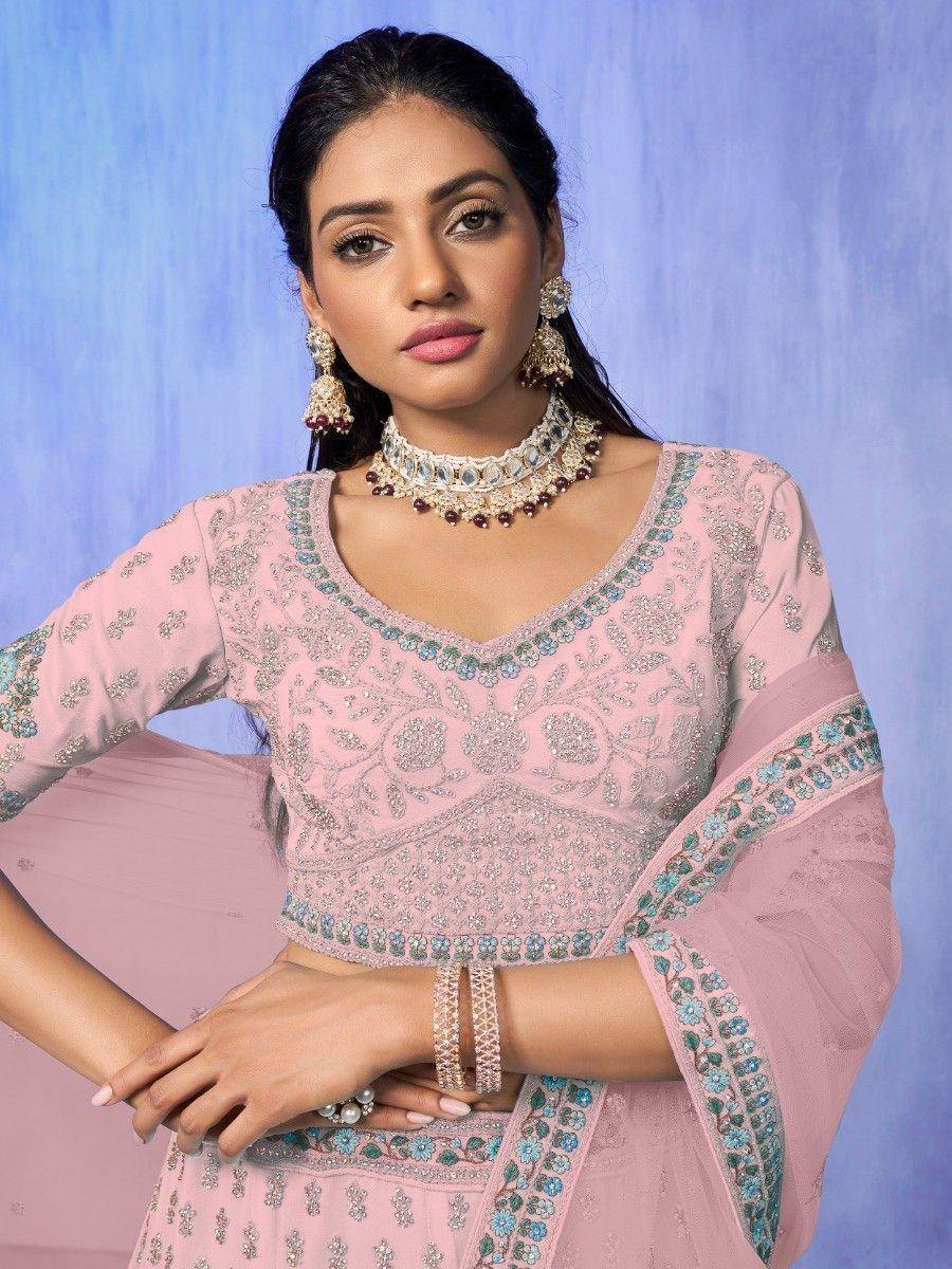 Pink embroidered designer lehenga choli with blue floral detailing and matching jewelry
