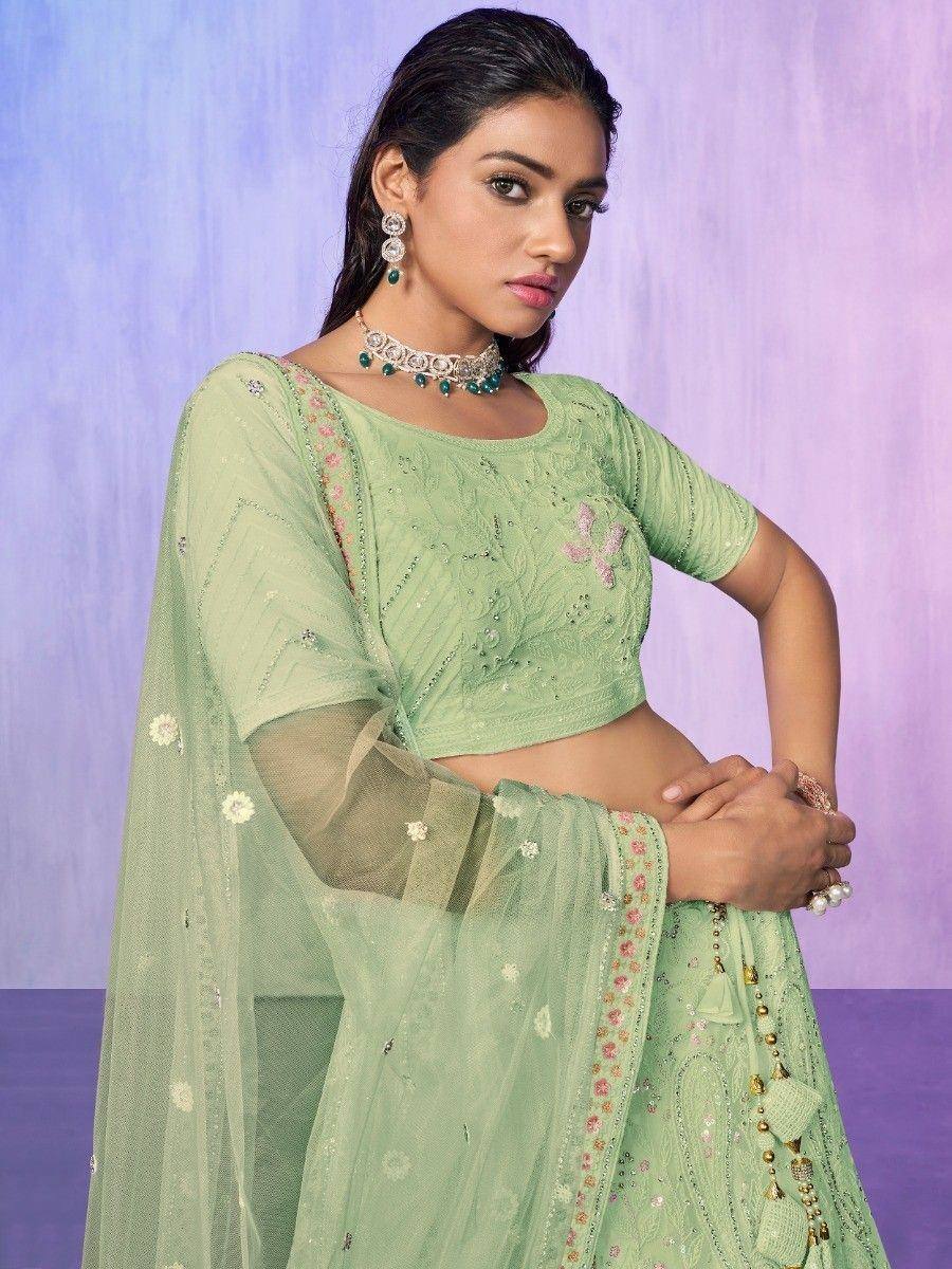 Mint green embroidered lehenga choli with floral net dupatta, perfect for Indian ethnic occasions