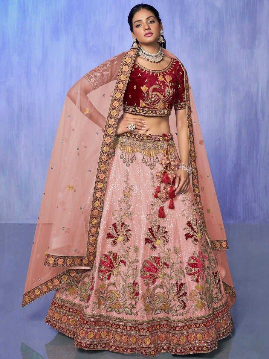 Pink and maroon embroidered lehenga choli with dupatta, perfect for Indian weddings and festive occasions.
