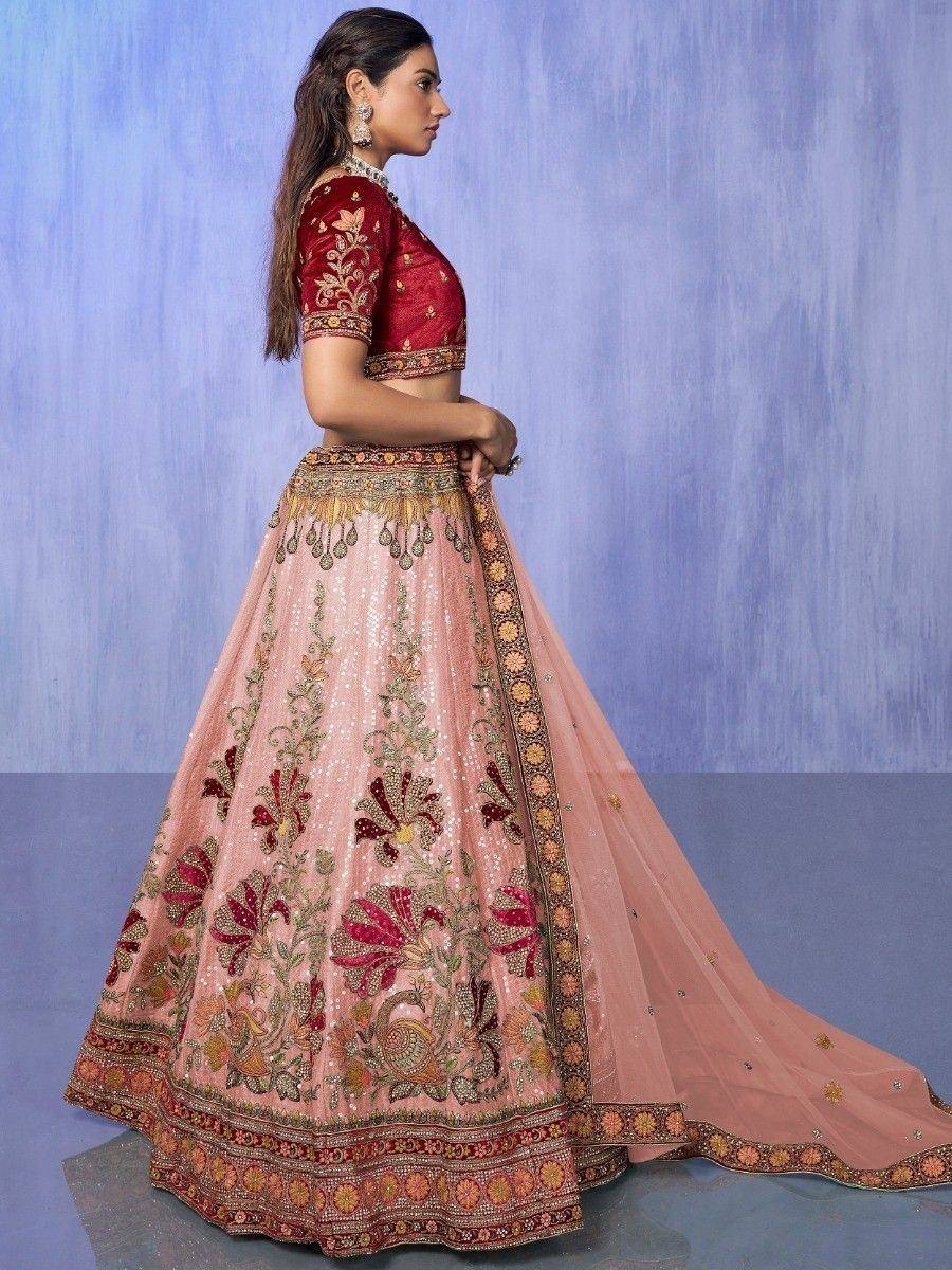 Pink and red embroidered lehenga choli with floral motifs and sequin work, perfect for Indian ethnic wear occasions.