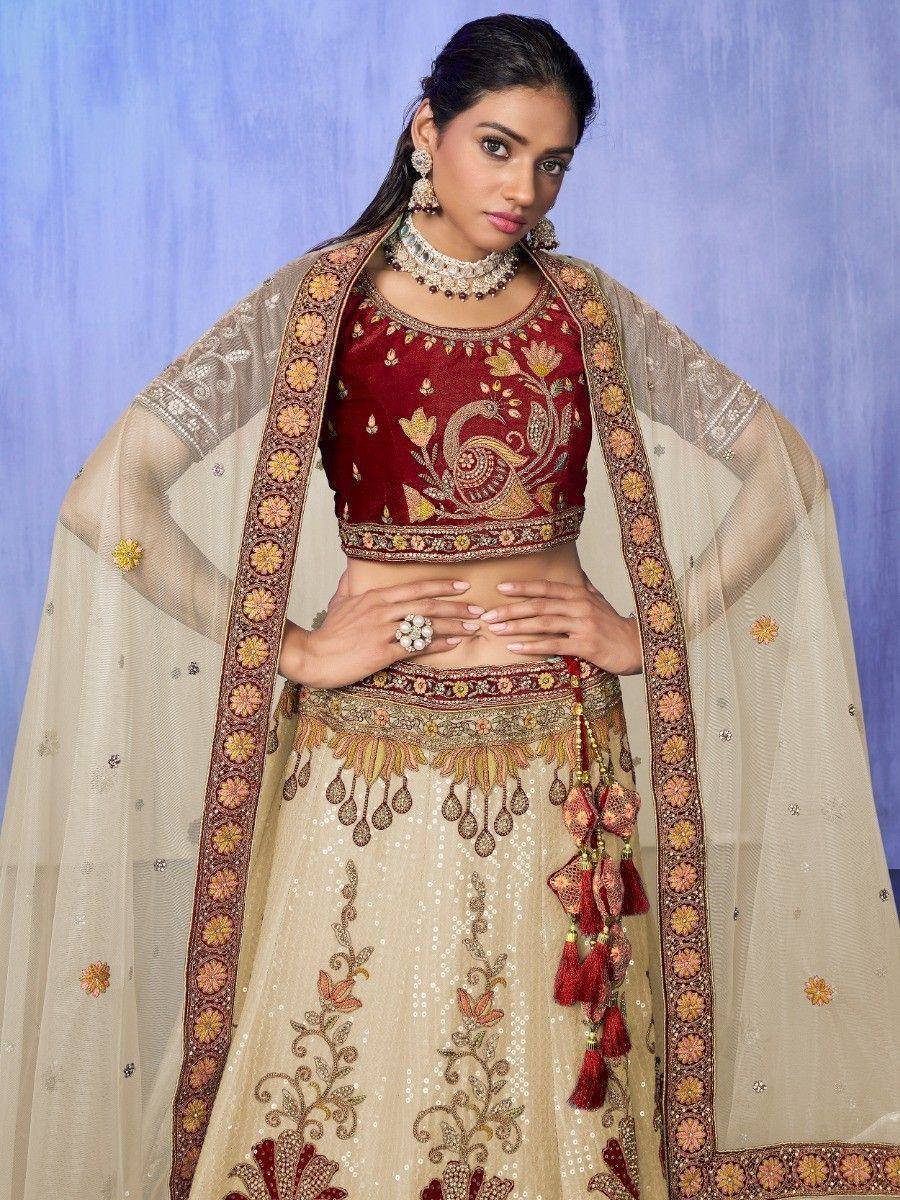 Maroon and beige embroidered lehenga choli with peacock motif, perfect for Indian ethnic wear occasions
