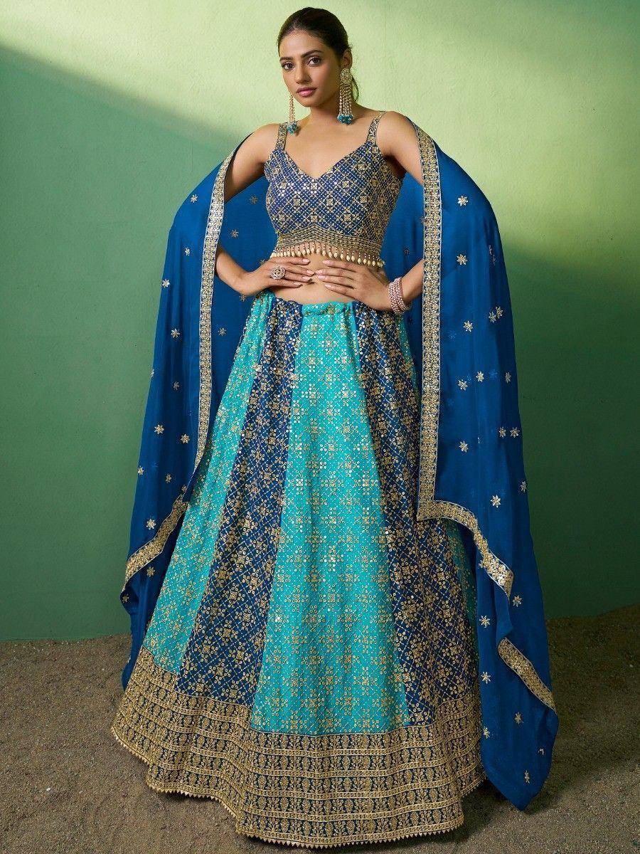 Blue and turquoise embroidered lehenga choli with gold detailing and matching dupatta, perfect for Indian weddings or festive occasions.