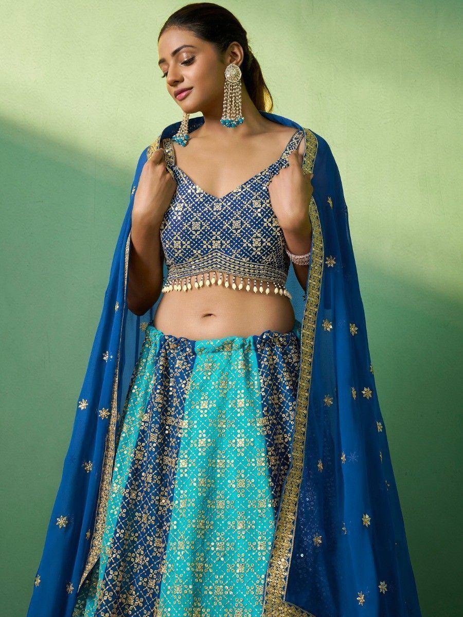 Blue and turquoise embroidered lehenga choli with gold detailing and matching dupatta, perfect for Indian ethnic wear.